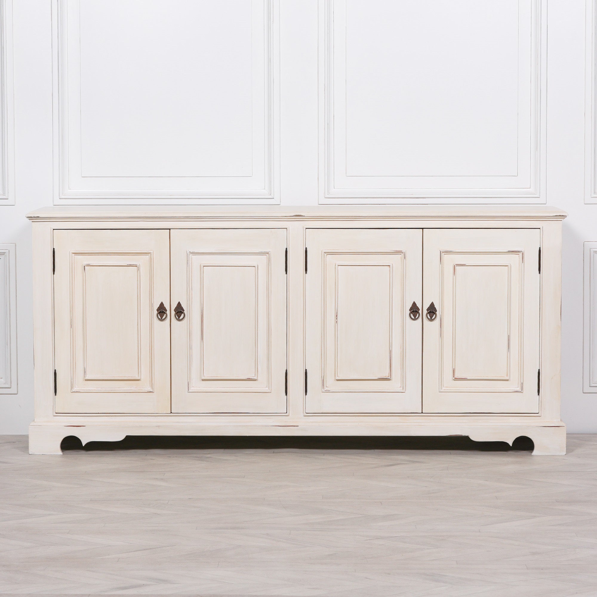 Front elevation of the Camille Four Door Classical Sideboard in an aged white mahogany finish featuring four traditional cupboard doors, elegant painted wood detailing and spacious concealed storage.
