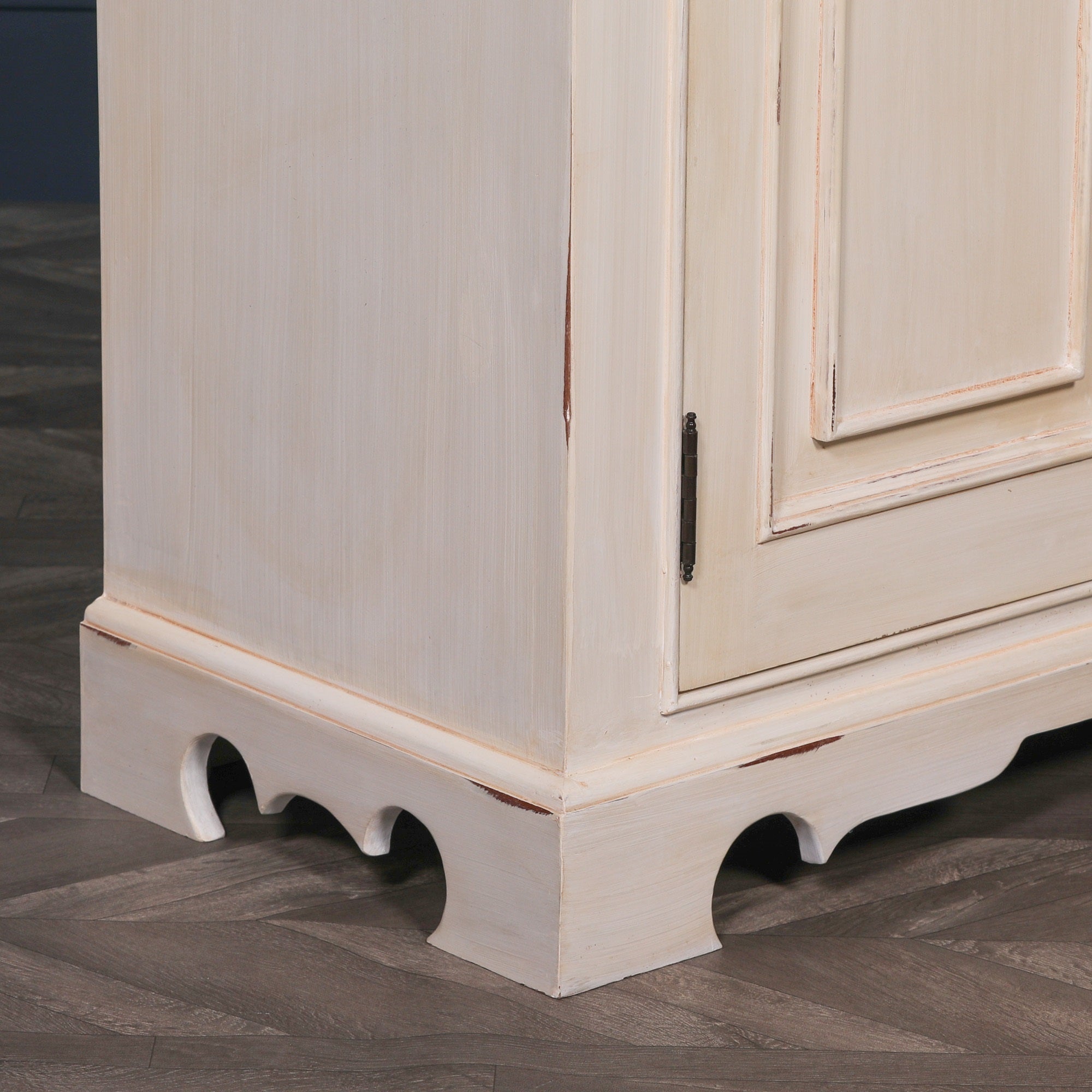 Close-up of the Camille Four Door Classical Sideboard highlighting the aged white mahogany finish, decorative plinth base, handcrafted cabinet construction and traditional painted wood detailing.