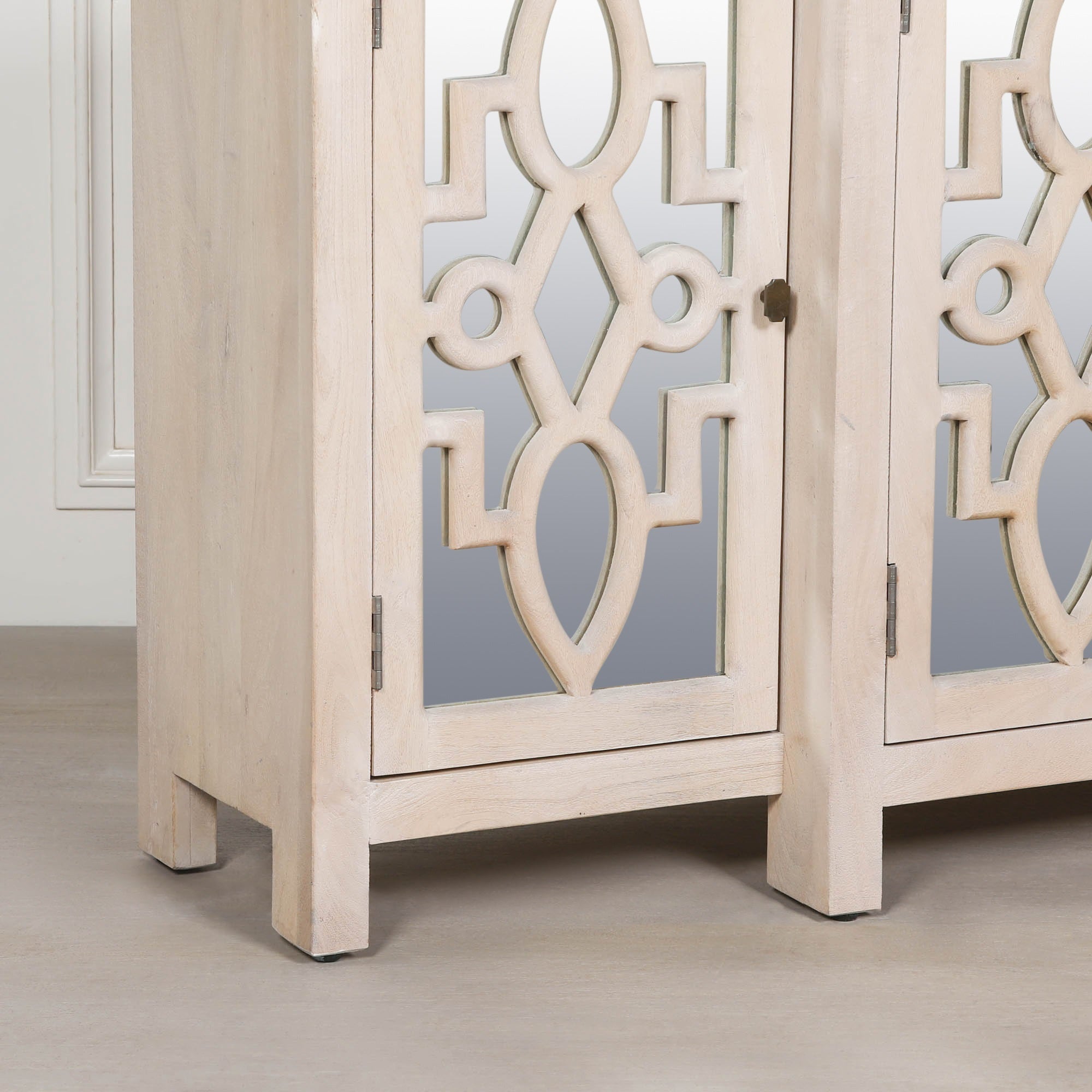 Corner detail of the Camille Four Door Mirrored Sideboard showcasing the bleached mango wood frame, mirrored cabinet door, premium craftsmanship and elegant contemporary furniture design.