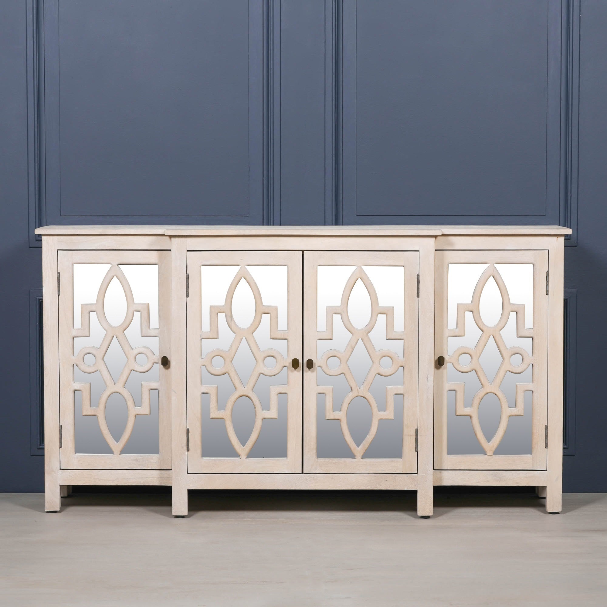 Front elevation of the Camille Four Door Mirrored Sideboard in bleached mango wood featuring four mirrored doors, handcrafted construction and elegant storage cabinet design for modern interiors.