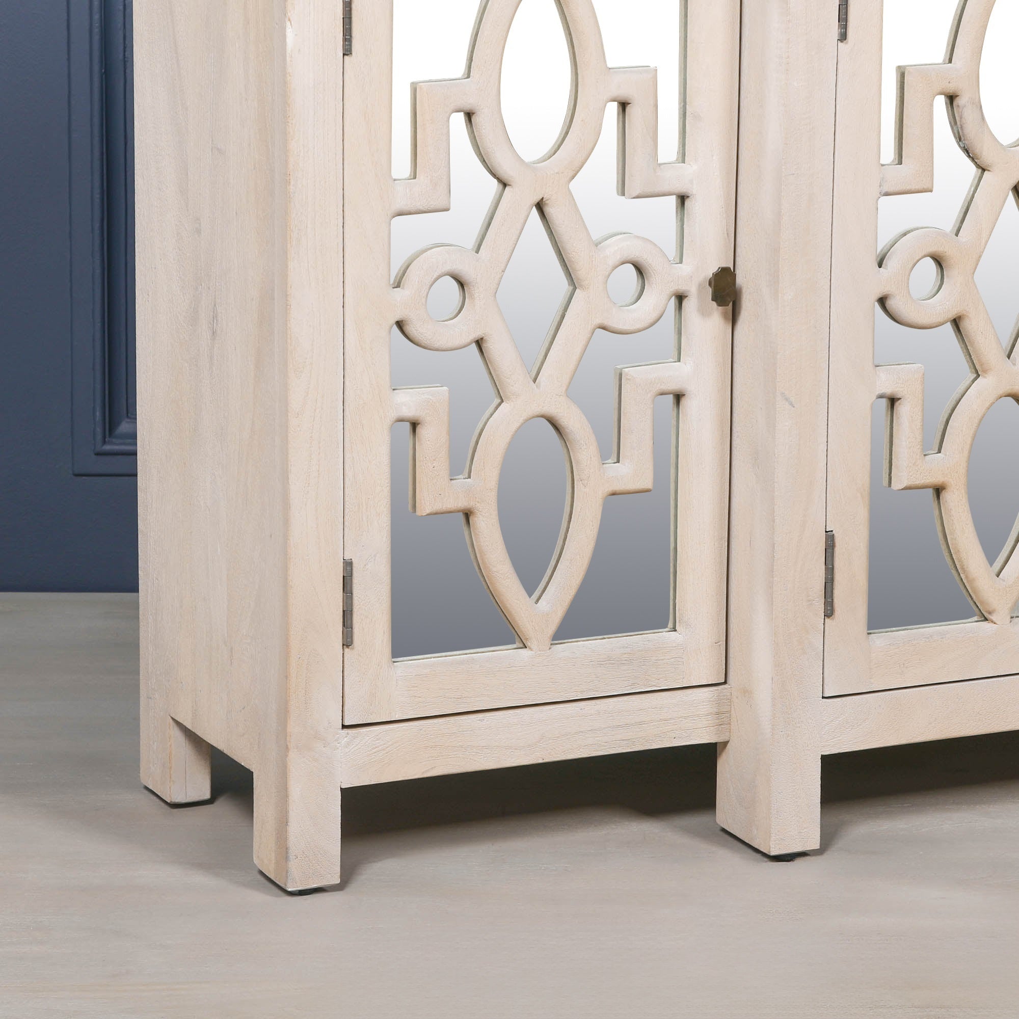 Close-up of the Camille Four Door Mirrored Sideboard featuring decorative mirrored cabinet doors, bleached mango wood construction and refined artisan furniture craftsmanship.