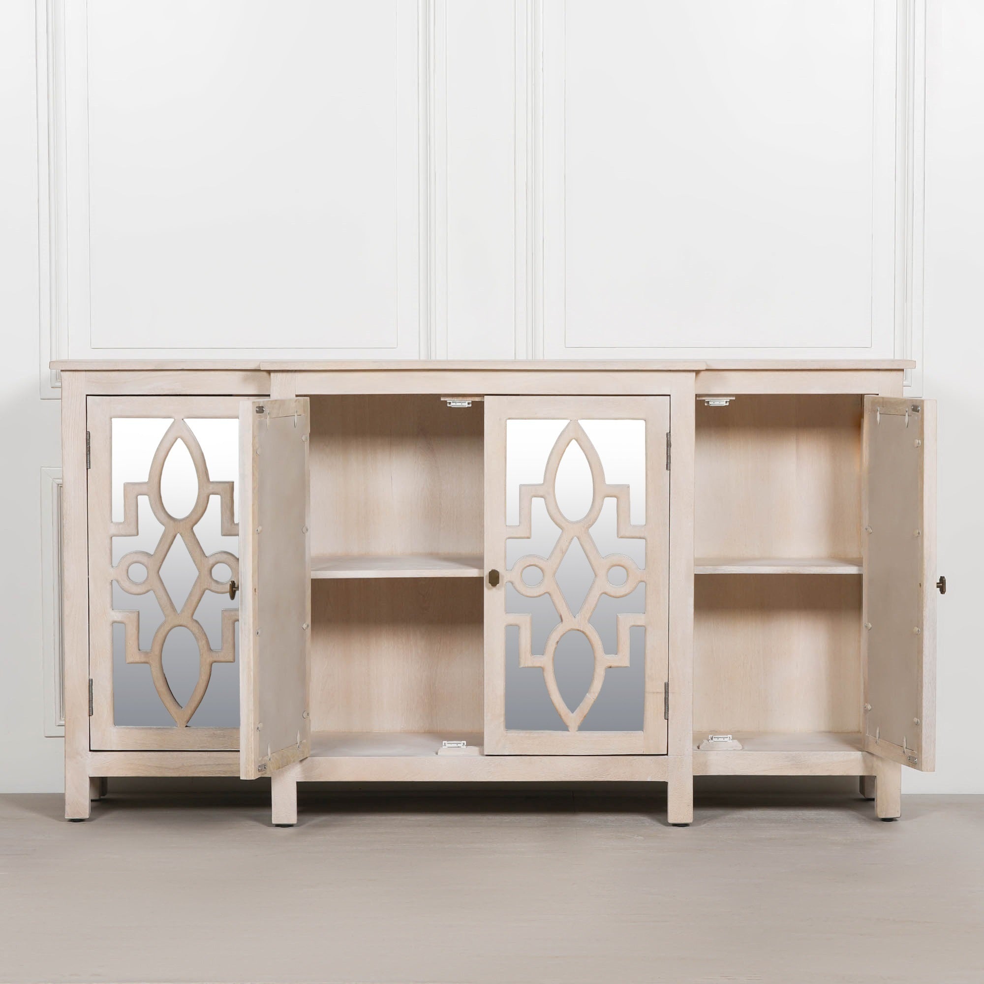 Camille Four Door Mirrored Sideboard with cupboard doors open displaying spacious internal shelving, mirrored centre doors and practical concealed storage for dining room and living room organisation.
