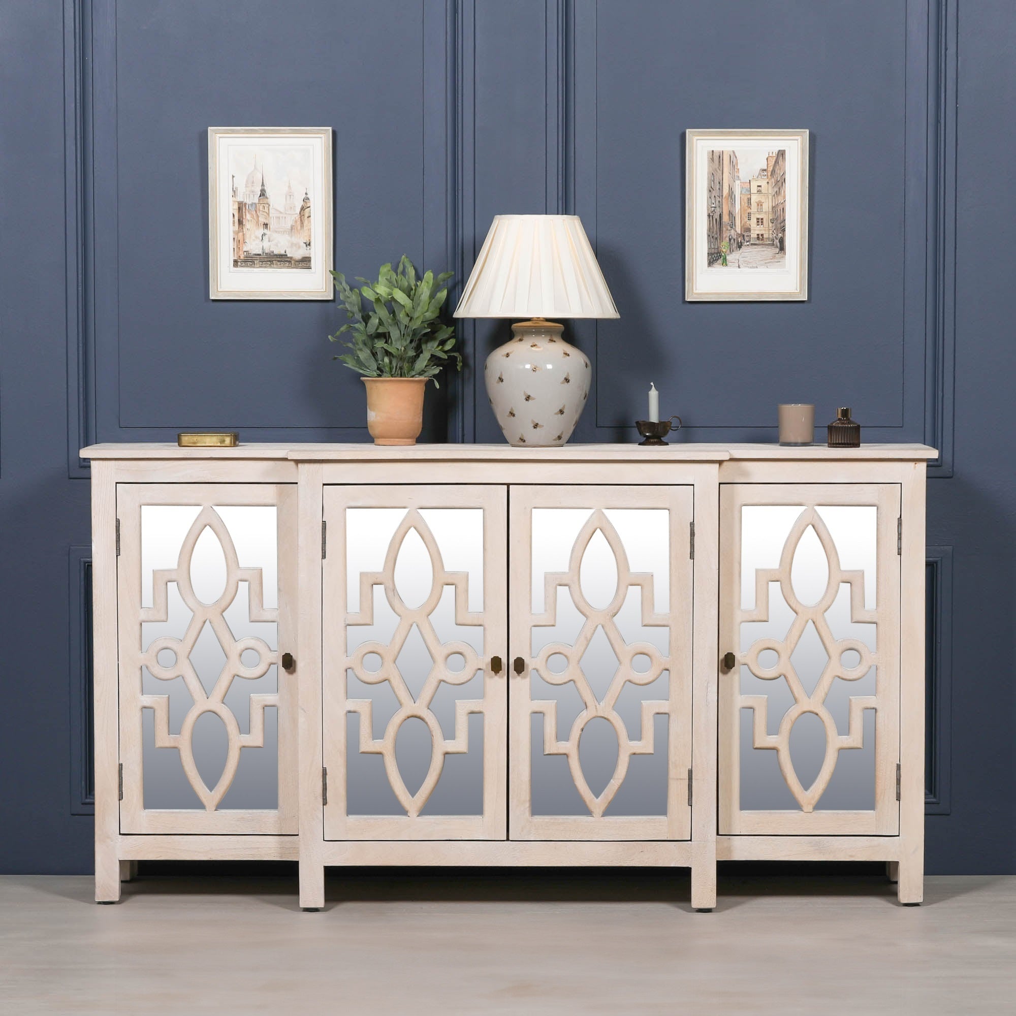 Camille Four Door Mirrored Sideboard in bleached mango wood styled with table lamps, artwork and decorative accessories, creating an elegant luxury living room or hallway display.