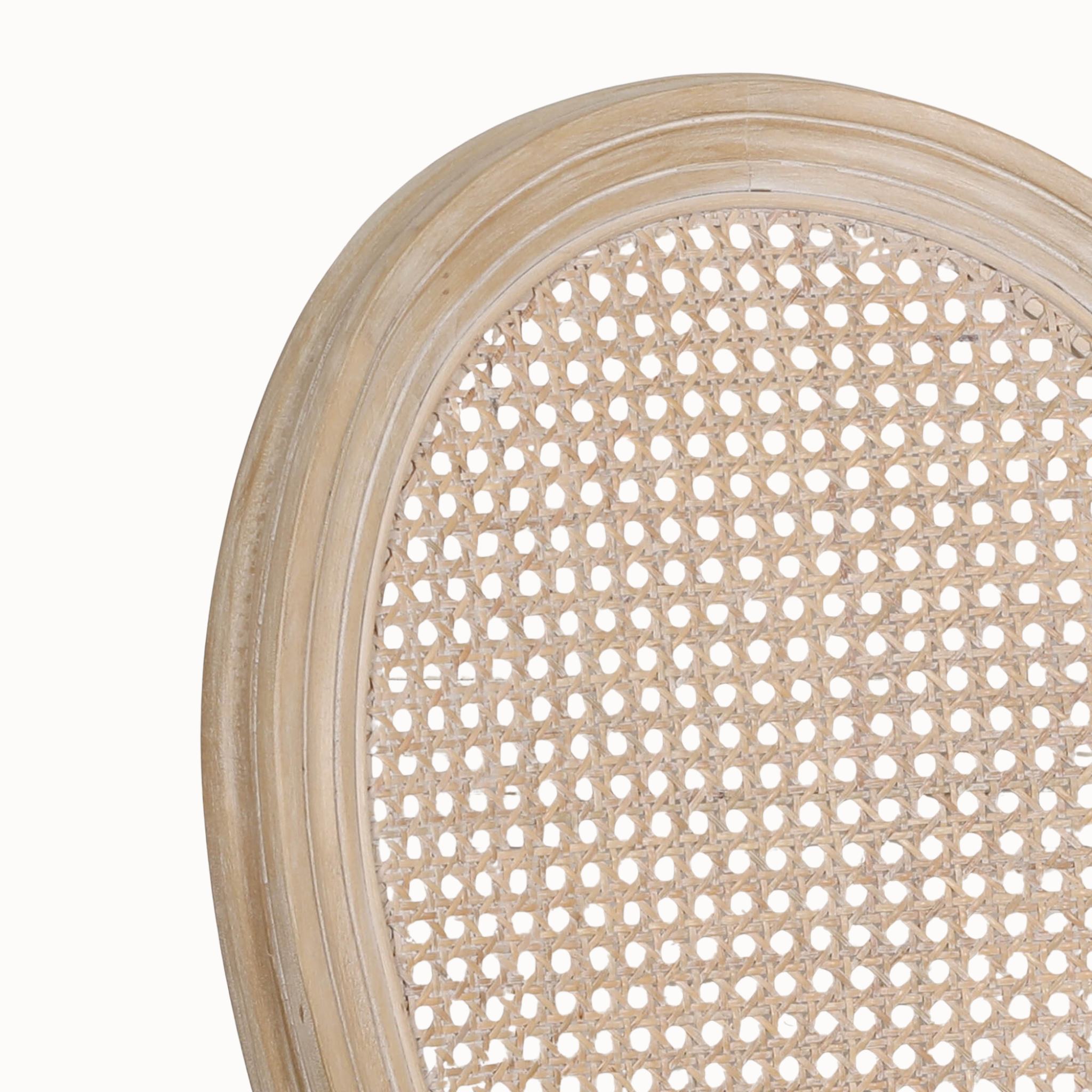 Close-up of Camille French Louis dining chair cane back and light washed wood frame against a clean white background.