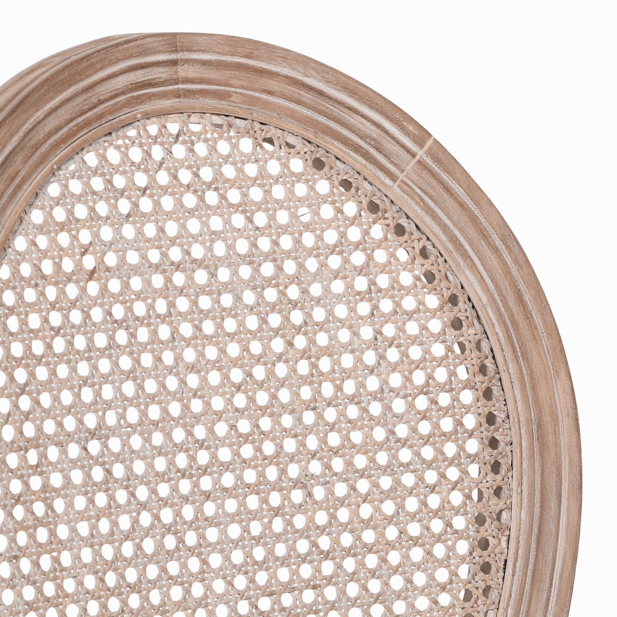 Close-up of Camille French Louis dining chair showing woven cane back and carved wooden frame on white.