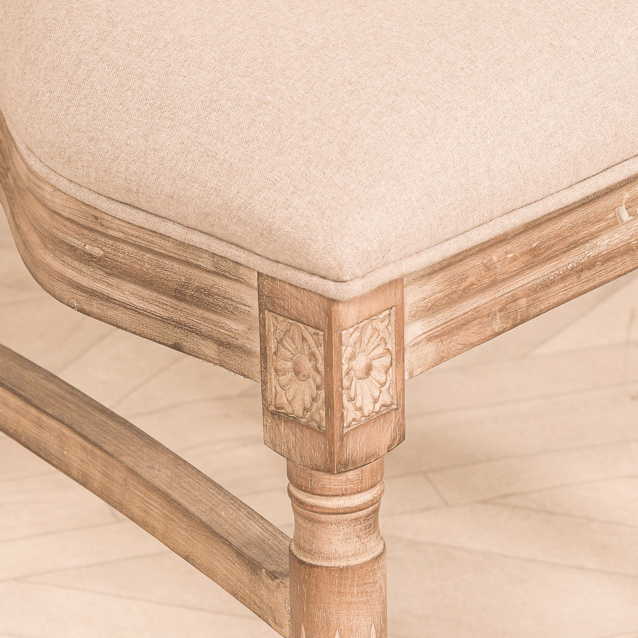 Close-up of the carved wooden leg, floral detailing and linen upholstered seat on the Camille French Louis Rattan Back Dining Chair, highlighting its handcrafted French-inspired design.