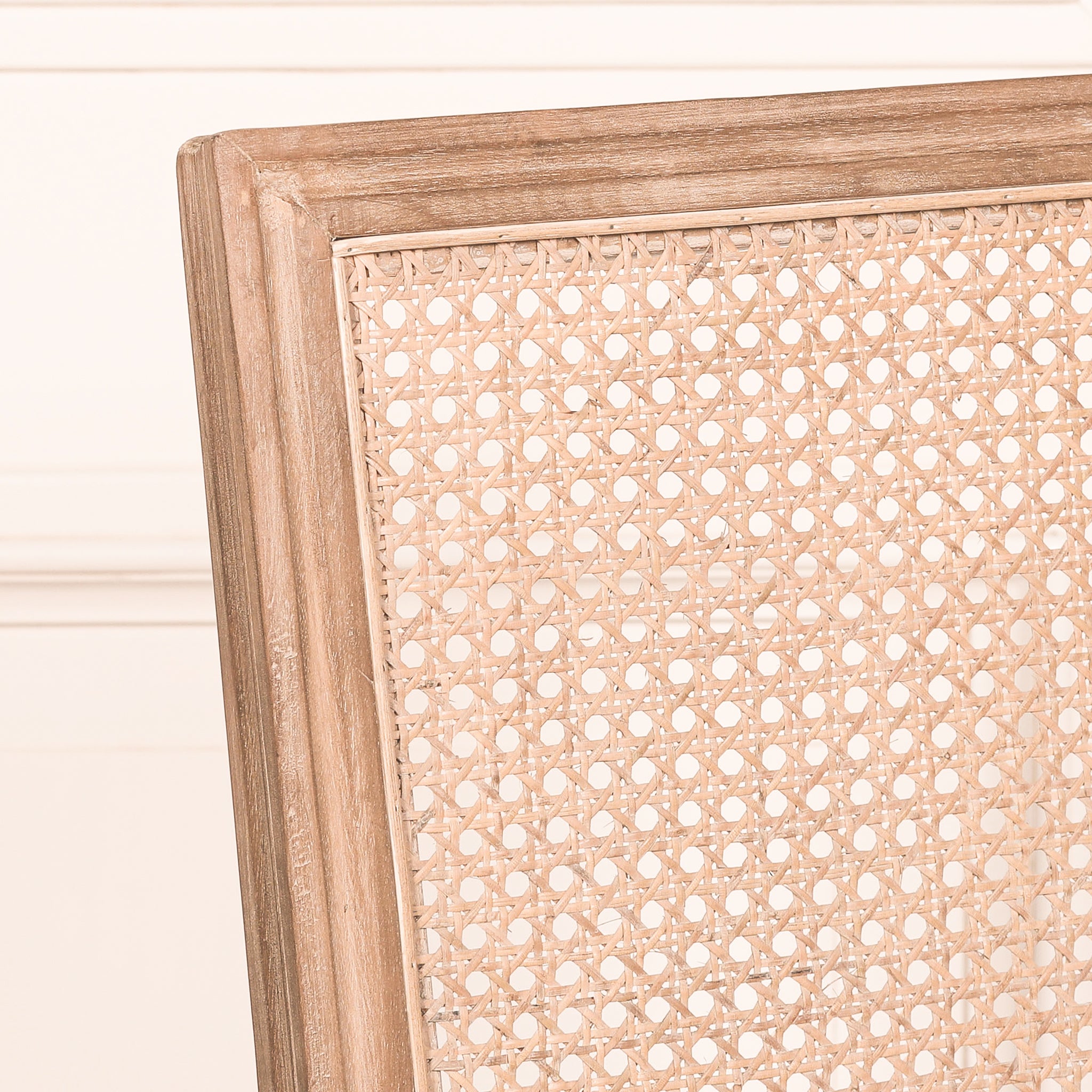 Close-up of the woven natural rattan backrest on the Camille French Louis Rattan Back Dining Chair with its carved wooden frame and French country design.