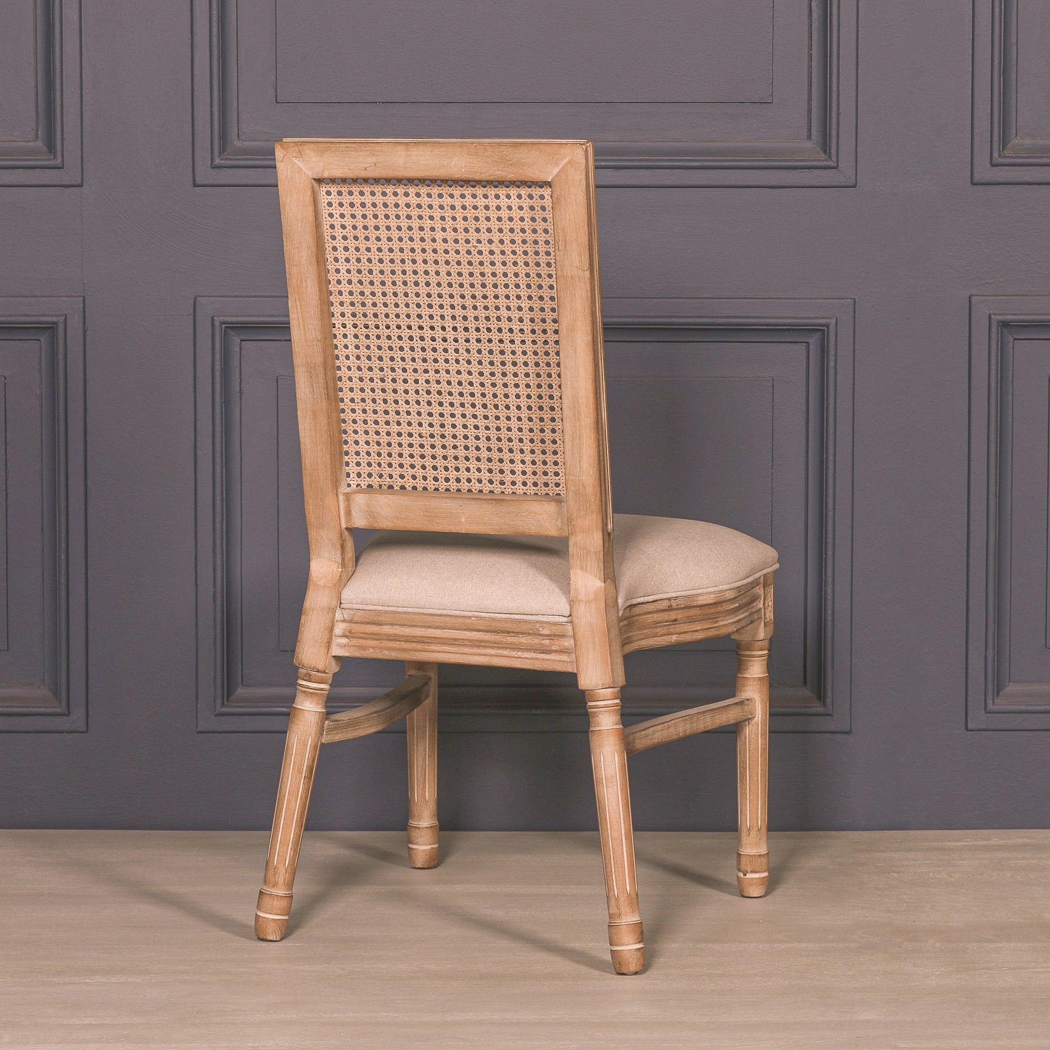 Rear three-quarter view of the Camille French Louis Rattan Back Dining Chair highlighting the woven rattan backrest, carved wooden frame and traditional French craftsmanship.