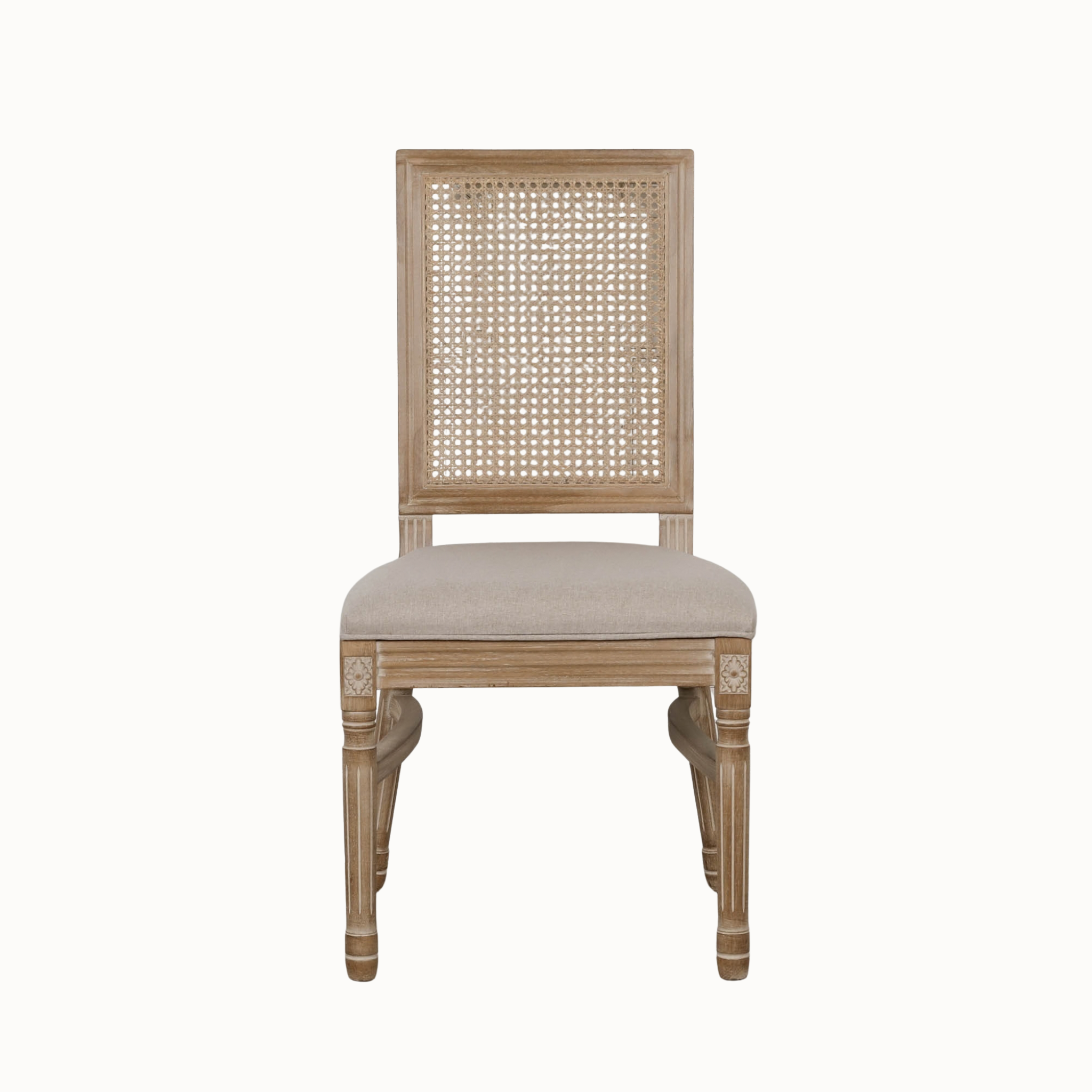 Front view of Camille French Louis rattan back dining chair with linen seat on a plain white background.