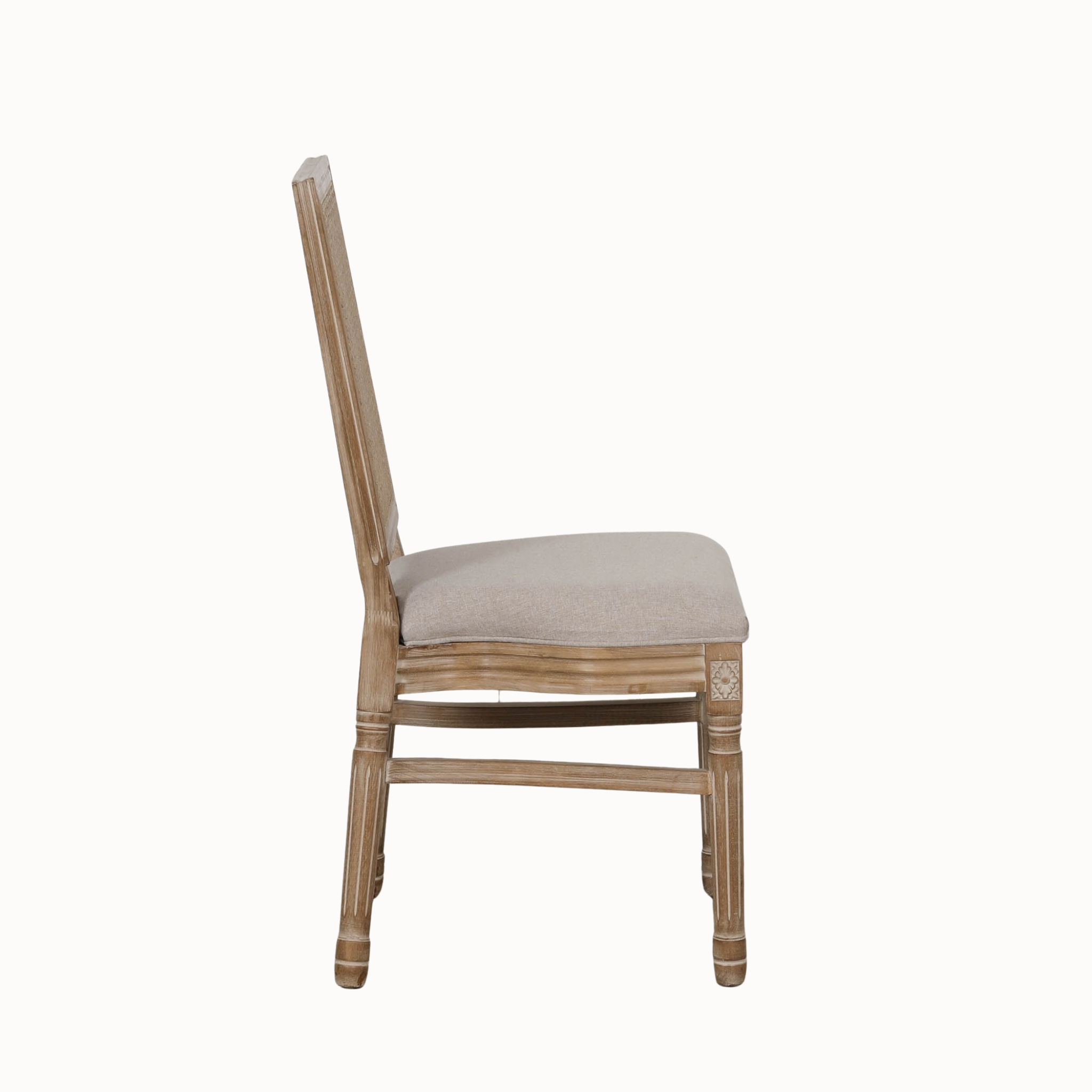 Side view of Camille French Louis dining chair with rattan back and linen seat on a plain white background.