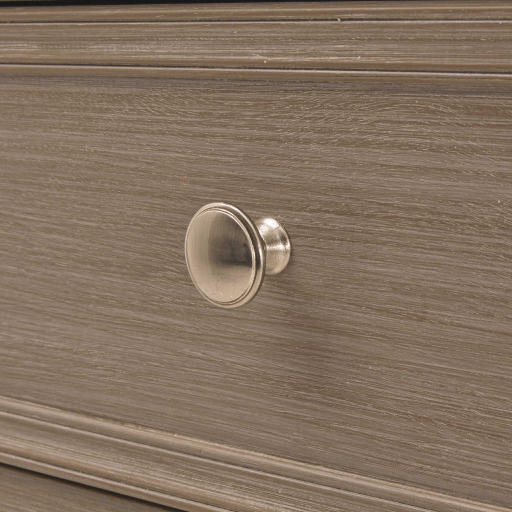 Detailed close-up of the Camille grey wooden chest of drawers featuring a brushed metal drawer knob, painted grey wood grain, framed drawer front and premium furniture craftsmanship, showcasing the elegant finishing details.