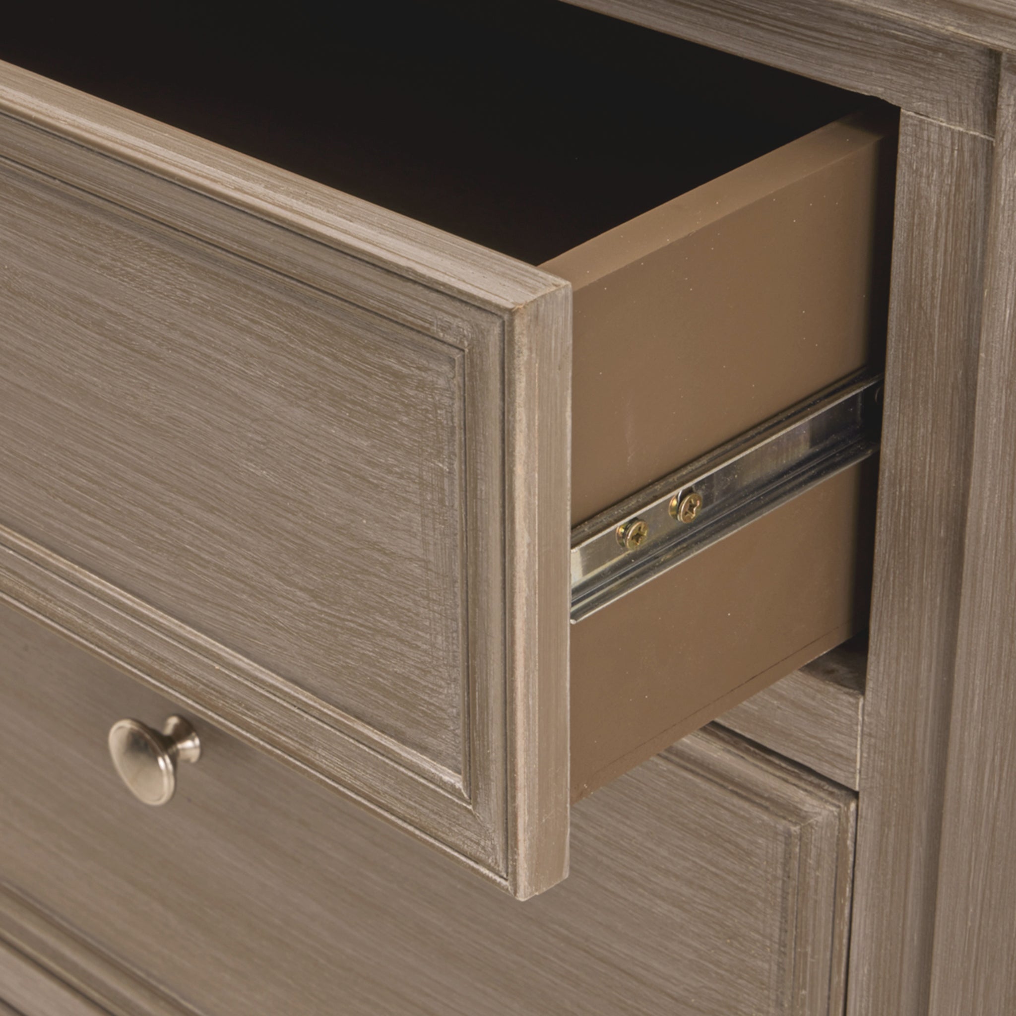 Close-up of the Camille grey wooden chest of drawers with drawer extended, revealing deep drawer storage, smooth metal runners, painted wood construction and practical organisation for clothing, accessories and bedroom essentials.