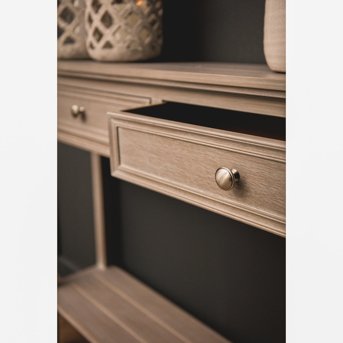 Close-up of the Camille grey wooden console table with an open storage drawer, showcasing the spacious drawer interior, painted wooden frame, brushed metal knob and practical hallway storage for everyday essentials.