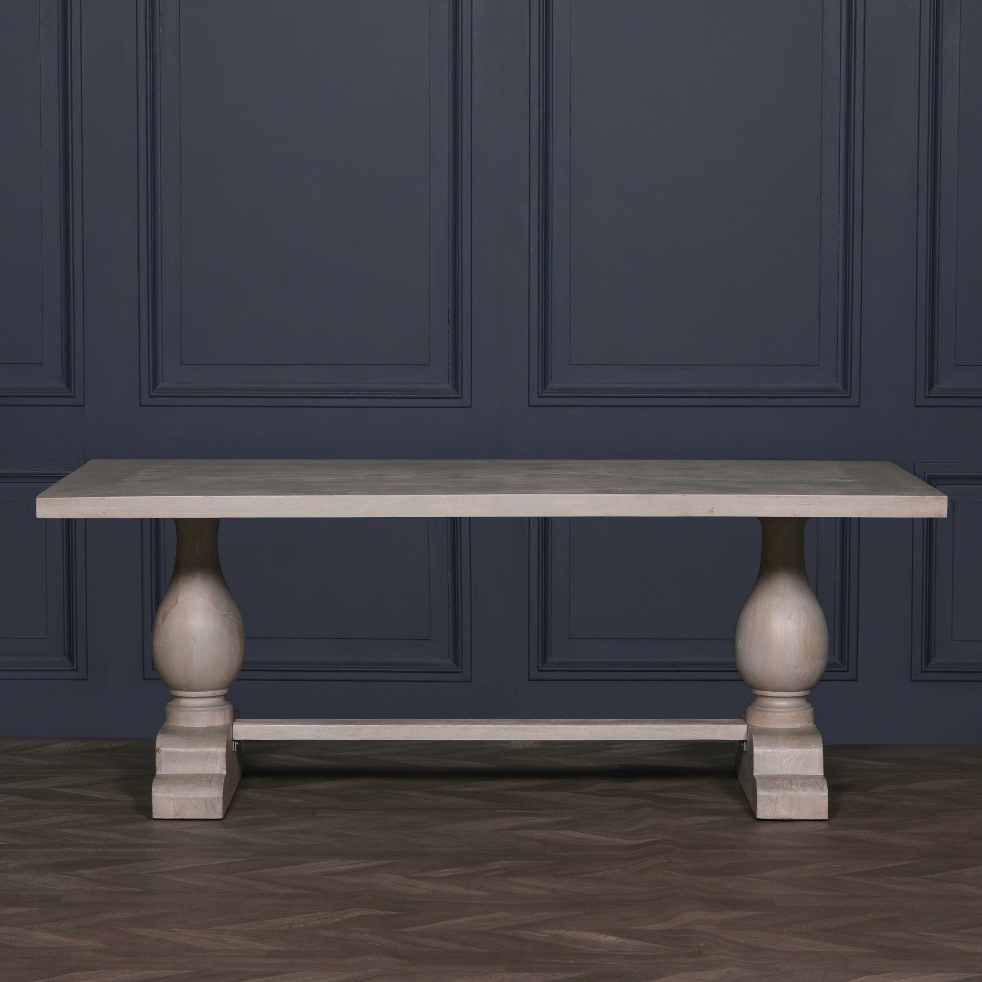 Front view of the Camille Large Rectangular Dining Table 210cm for 8–10 in Bleached Mango Wood against a dark backdrop, highlighting the handcrafted solid mango wood tabletop, twin pedestal base and elegant contemporary silhouette.