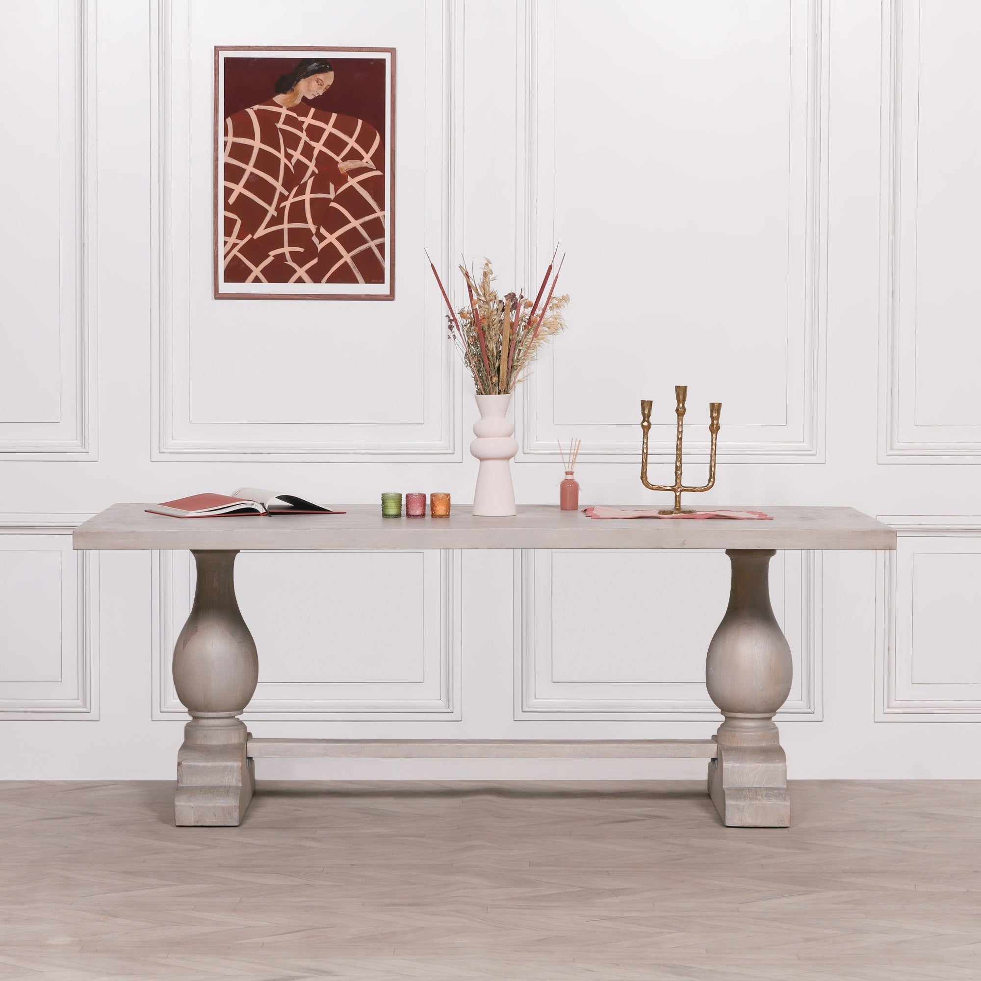 Styled front view of the Camille Large Rectangular Dining Table 210cm for 8–10 in Bleached Mango Wood with decorative accessories, highlighting the handcrafted solid mango wood construction and elegant double pedestal design.