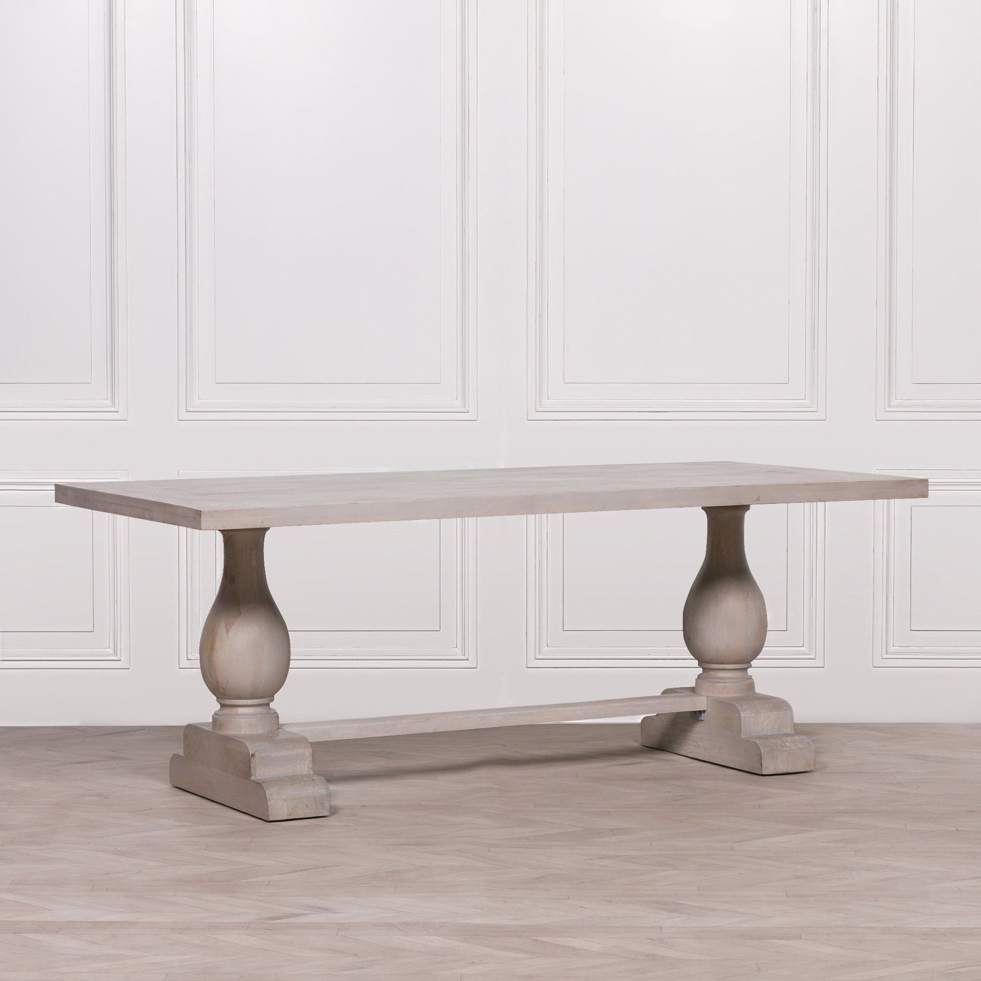Three-quarter view of the Camille Large Rectangular Dining Table 210cm for 8–10 in Bleached Mango Wood showcasing the expansive rectangular tabletop, turned pedestal base and solid wood trestle construction for stylish family dining and entertaining.