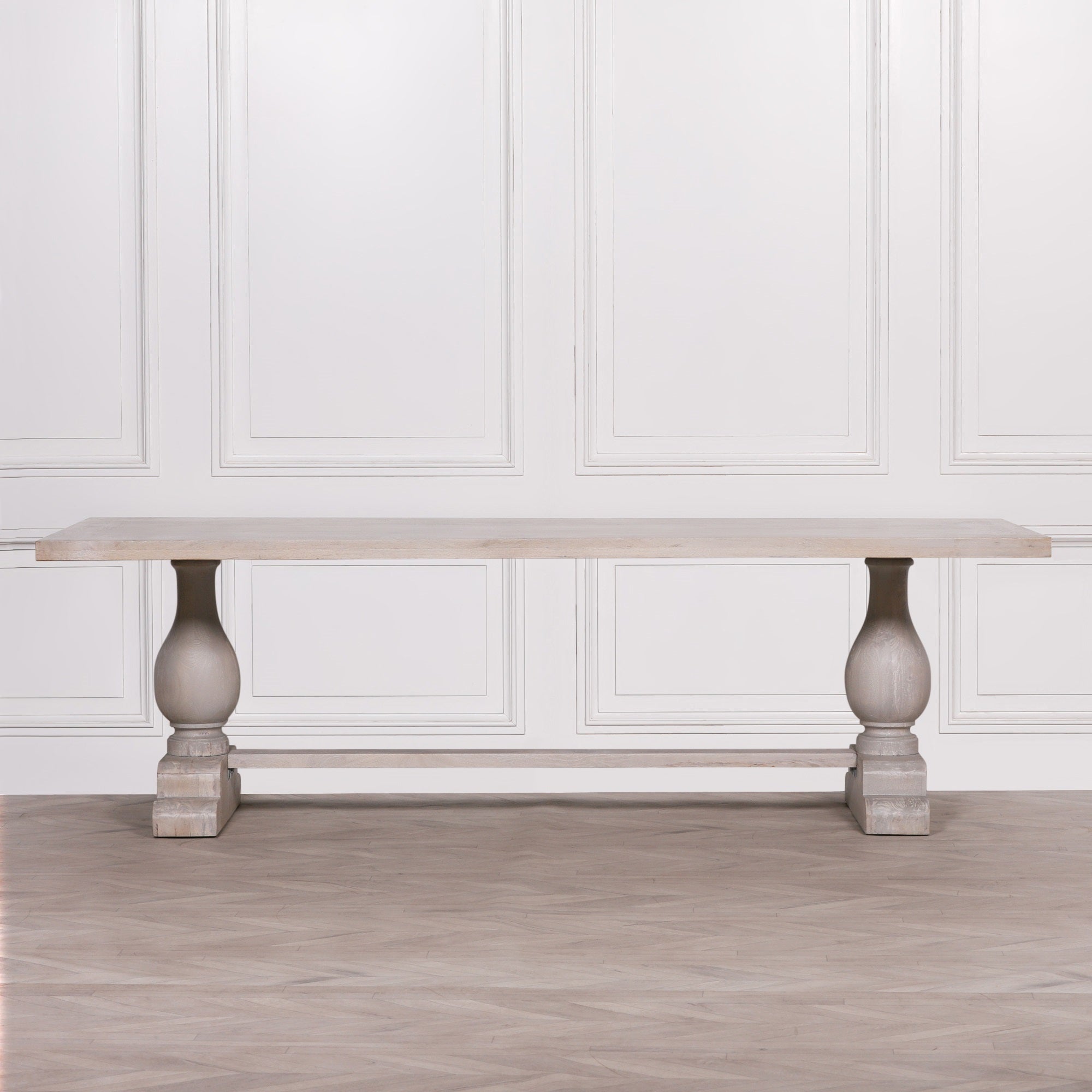 Front view of the Camille Large Rectangular Dining Table 260cm for 10–12 in Bleached Mango Wood highlighting the substantial rectangular tabletop, twin turned pedestal legs, solid trestle base and handcrafted natural wood finish for luxury dining room interiors.