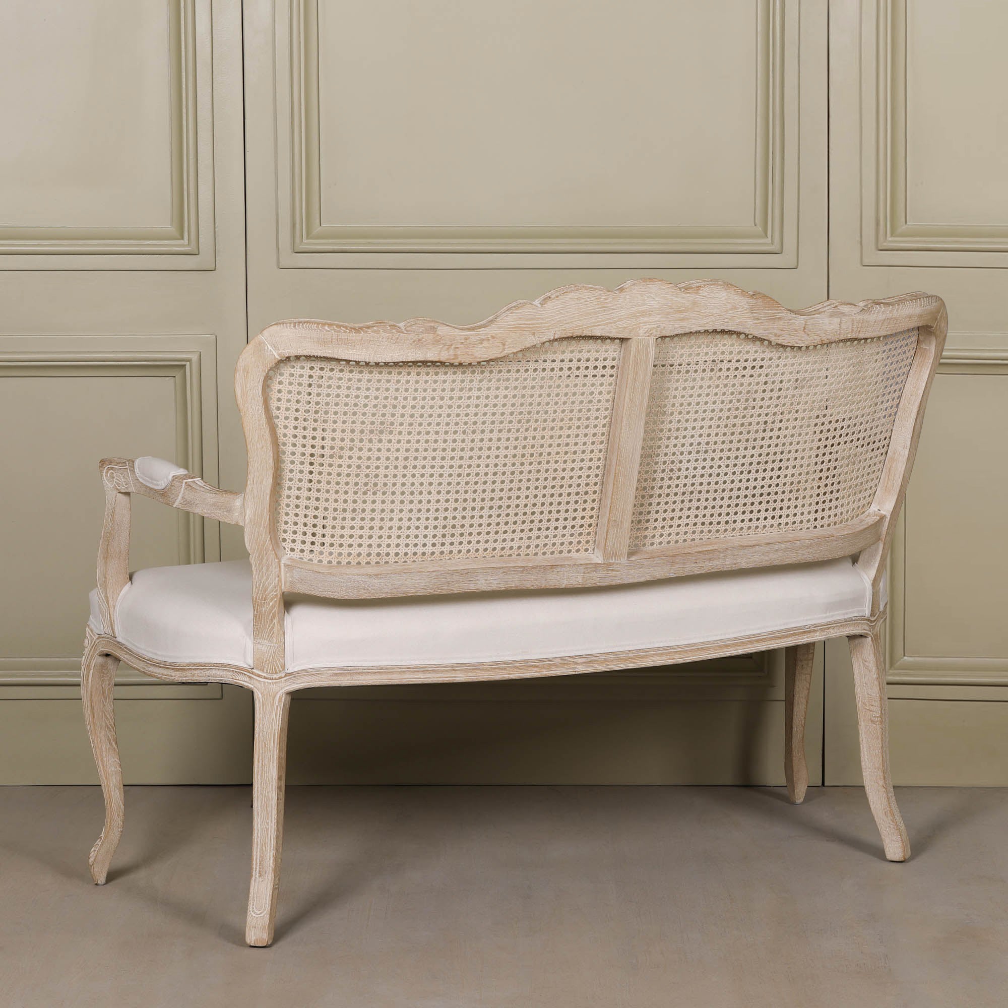 Rear view of Camille Louis 2 seater settee showing carved birch wood frame, curved legs and natural cane back.