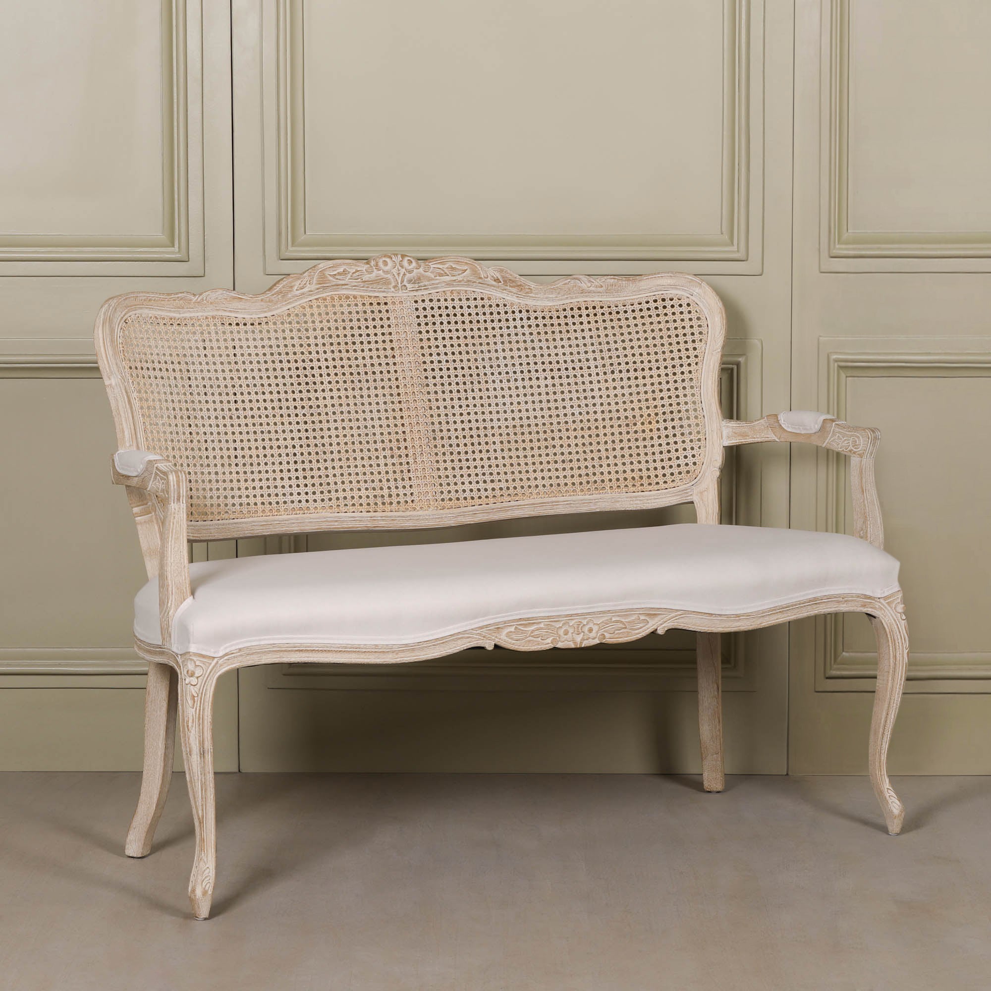 Camille Louis 2 seater settee with birch wood frame, natural cane back and cream linen upholstered seat.
