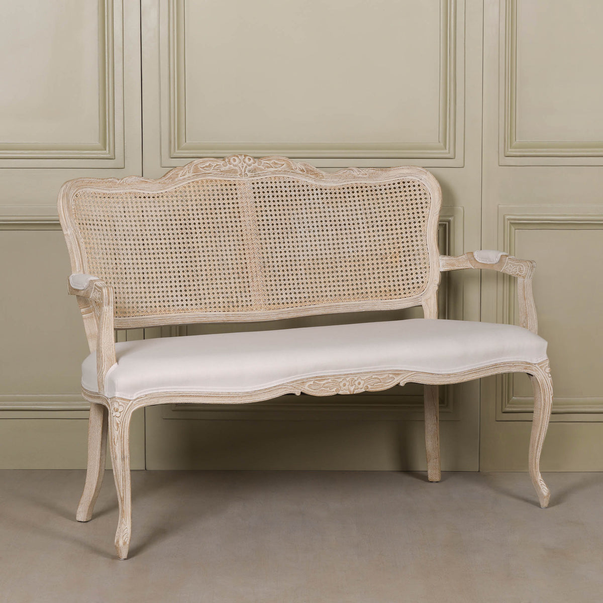 Camille Louis 2 seater settee with birch wood frame, natural cane back and cream linen upholstered seat.