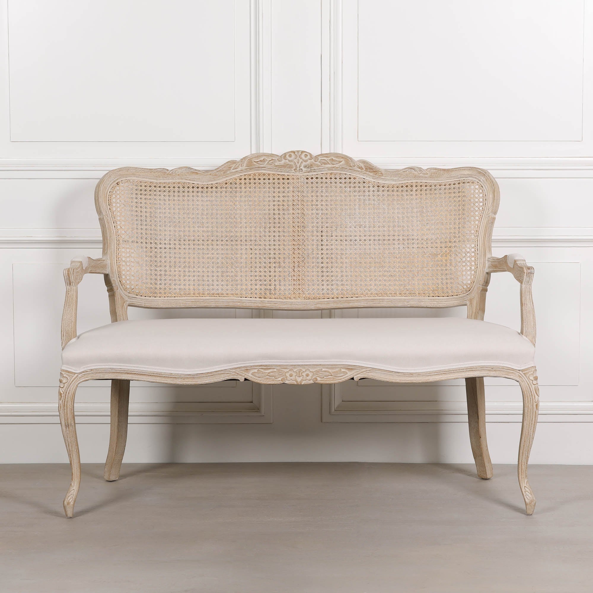 Camille Louis 2 seater settee front view with natural cane back, birch wood frame and cream linen upholstered seat.
