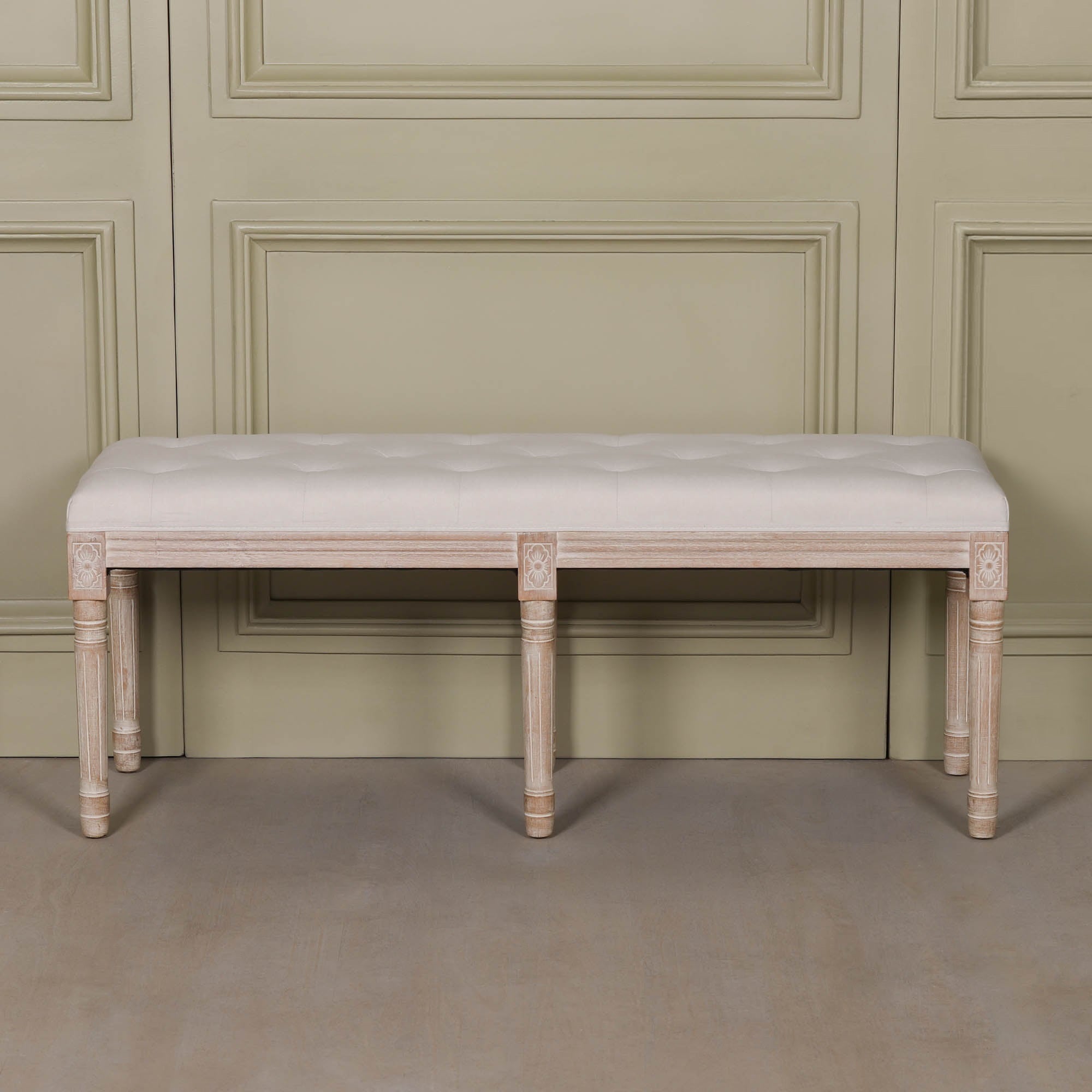 Front view of the Camille Louis Upholstered Bench with a beige button tufted linen seat, hand-carved washed birch wood frame and turned legs, creating an elegant French Louis style bench for bedrooms, hallways or dining rooms.