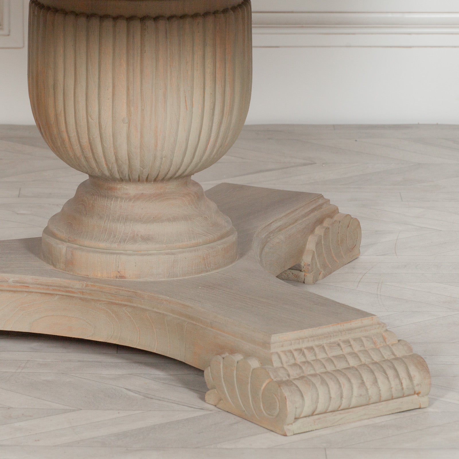 Close-up of the carved fluted pedestal base on the Camille Round Pedestal Dining Table 150cm for 6, highlighting the handcrafted Rustic White Cedar Wood finish, decorative carved feet, premium craftsmanship and traditional French country inspired detailing.