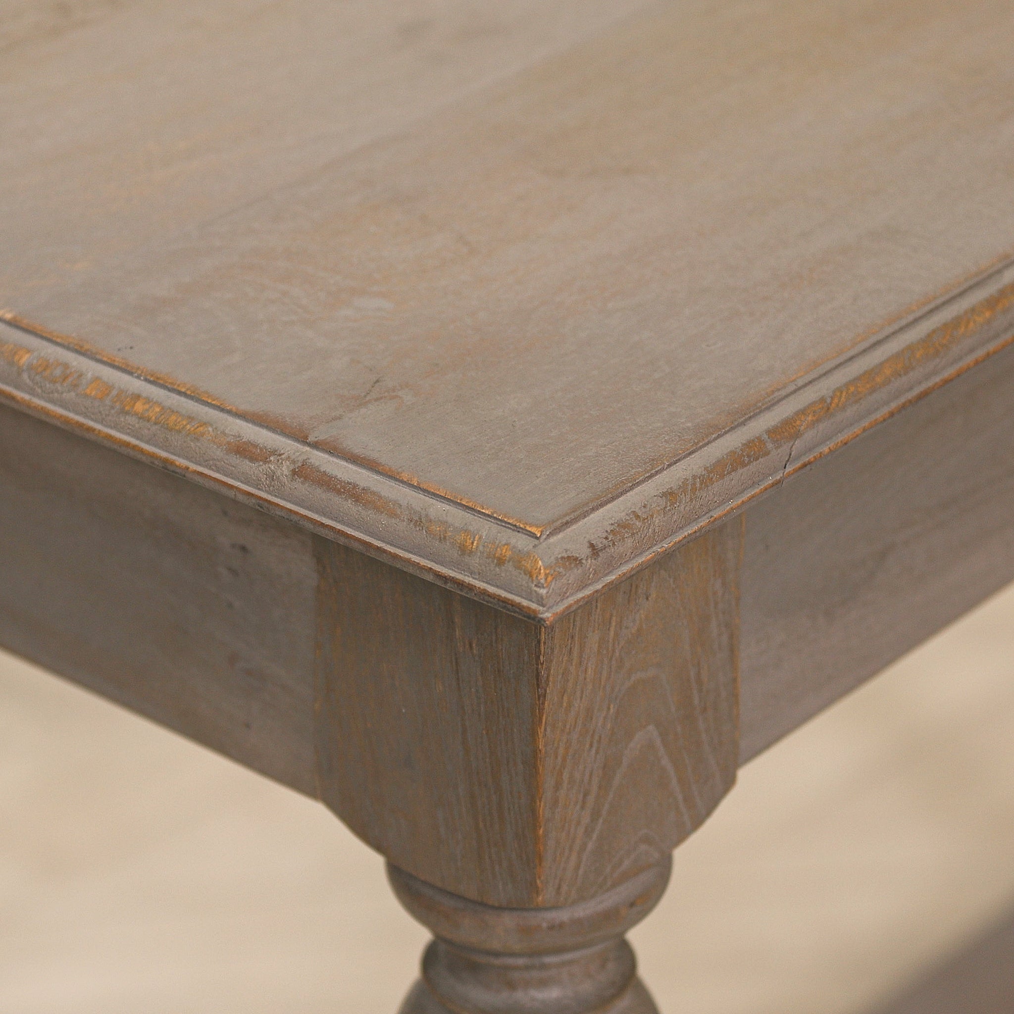 Close-up of the Camille rustic wooden console table showing the distressed weathered wood tabletop, bevelled edge detailing and handcrafted rustic finish.