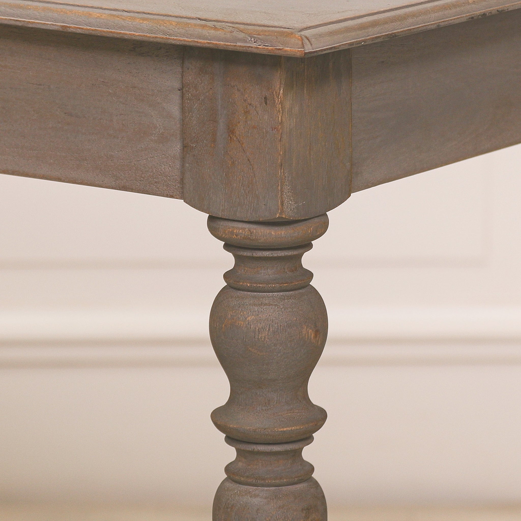 Detailed close-up of the turned column leg on the Camille rustic wooden console table, highlighting the traditional spindle craftsmanship, solid wood construction and weathered rustic grey finish.