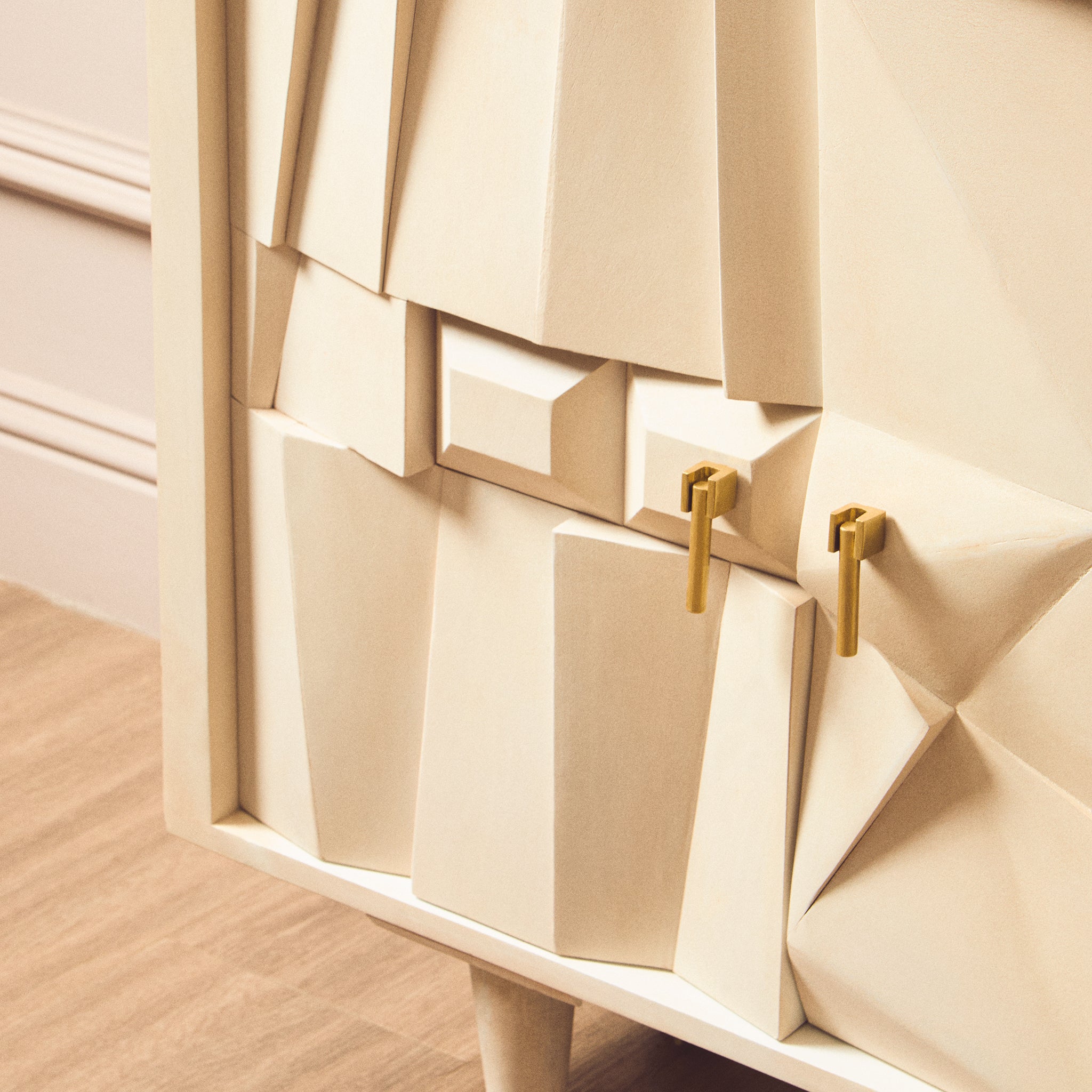 Detailed view of the Camille Four Door Sideboard featuring sculptural geometric mango wood panels, brushed brass handles and whitewashed finish.