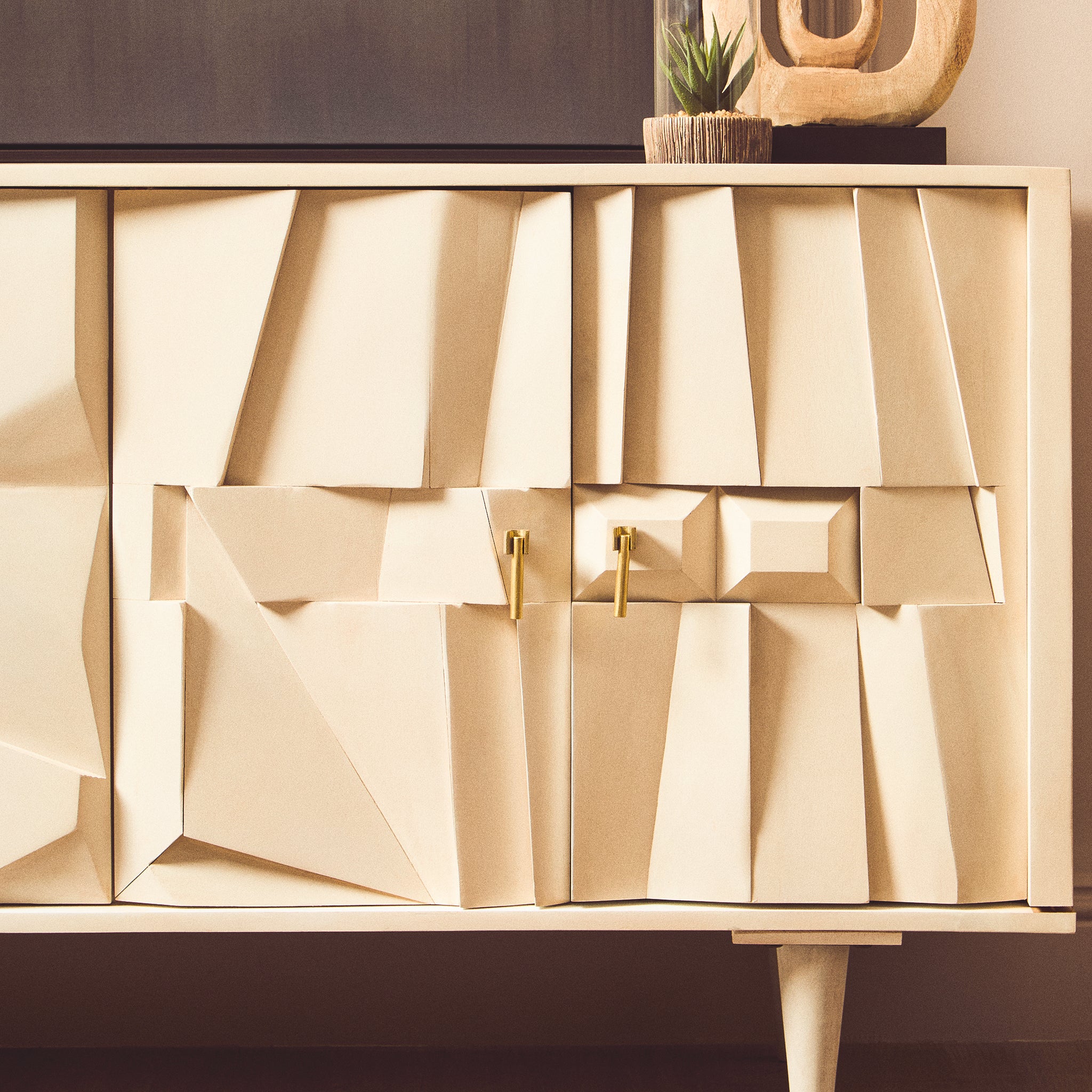Close-up of the Camille Four Door Mango Wood Sideboard in a whitewashed finish with handcrafted geometric doors, brass handles and contemporary styling.