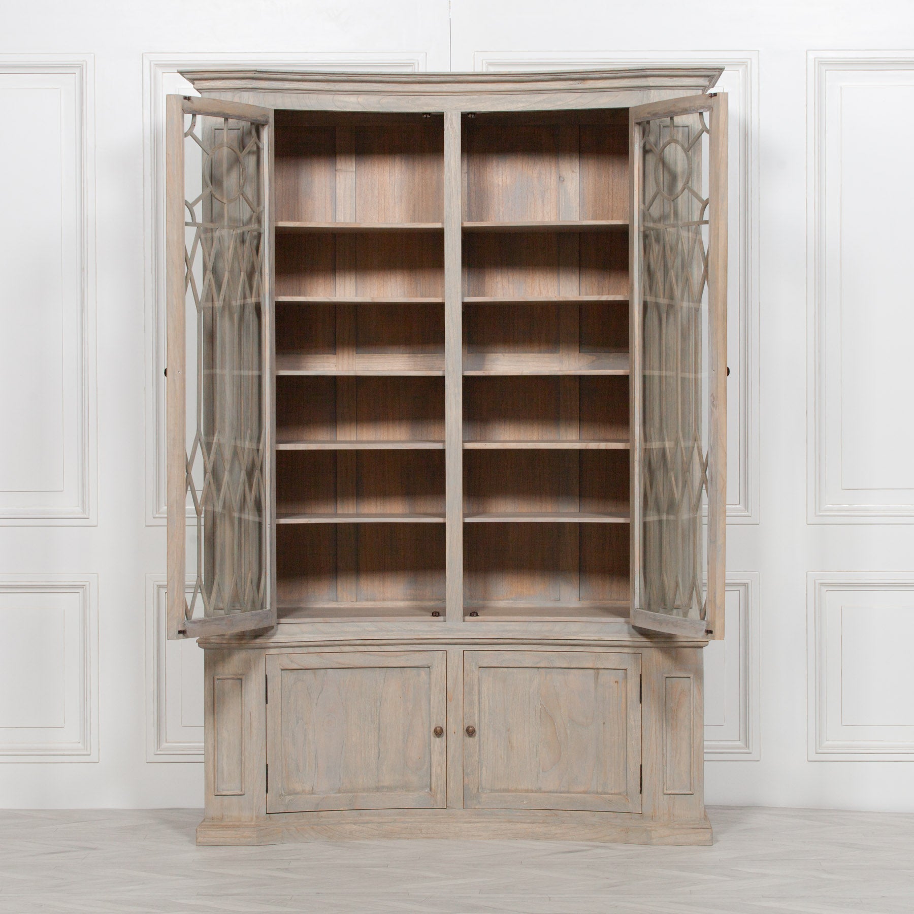 Camille white cedar display cabinet with open decorative glass doors and internal shelving against a panelled wall.