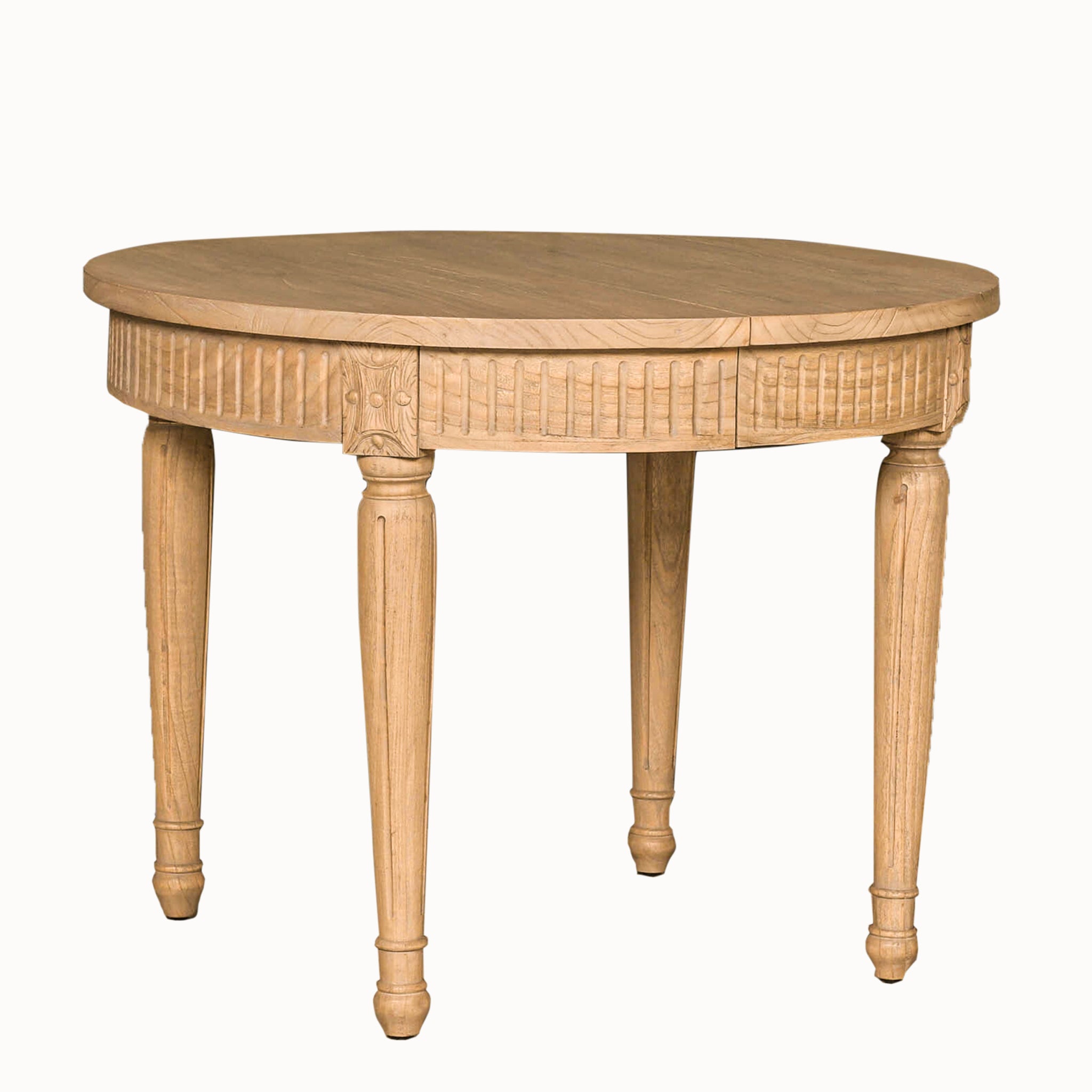 Camille White Cedar Wood Extendable Dining Table in its compact 100cm round configuration with a rustic finish on a white background, featuring carved detailing, 4 decorative legs, solid cedar wood construction and seating for 4 people.