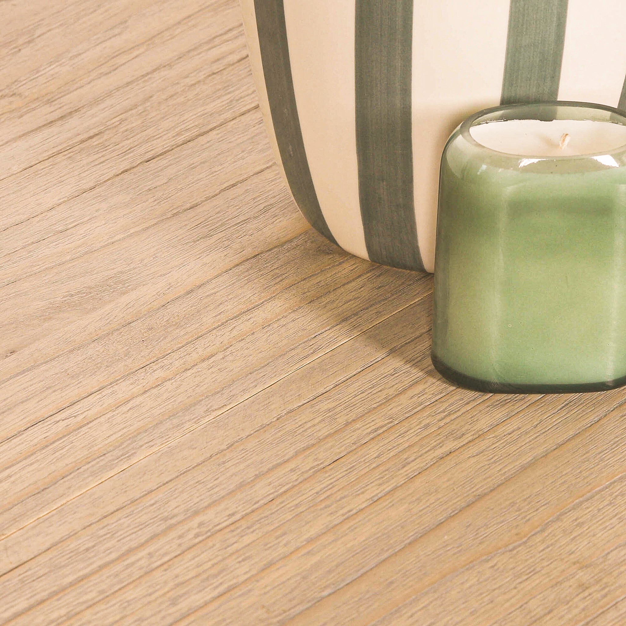 Close-up of the Camille White Cedar Wood Extendable Dining Table tabletop displaying the natural rustic white cedar wood grain, extension seam and smooth timber finish with decorative styling accessories.