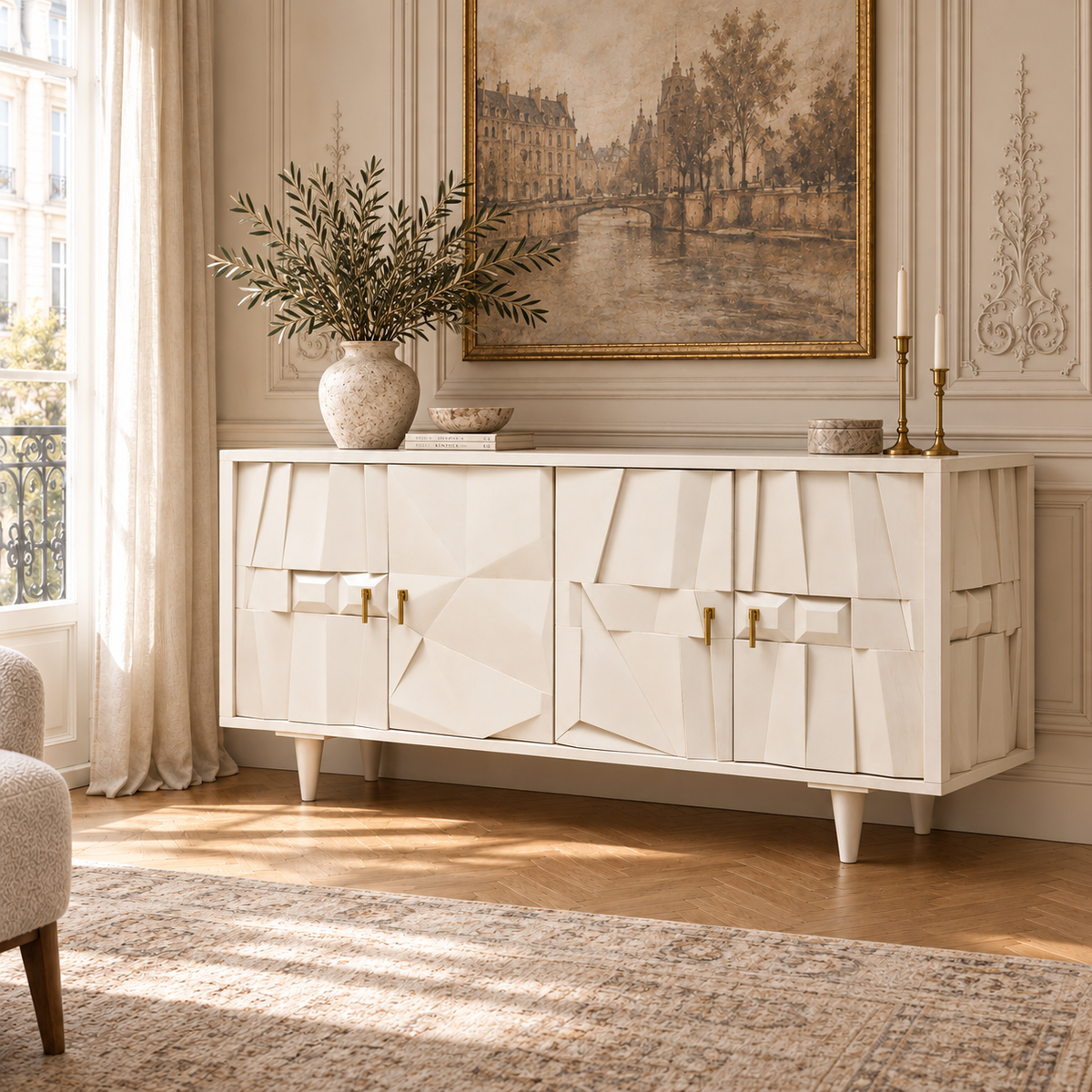 Camille whitewashed mango wood four door sideboard with brass handles in a Parisian room with artwork and rug