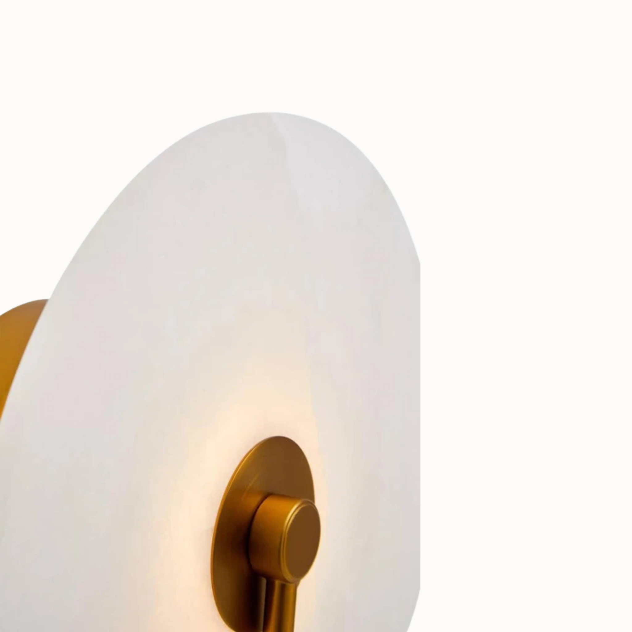 Close-up of white marble LED wall light and gold metal fitting glowing softly against a clean white background.