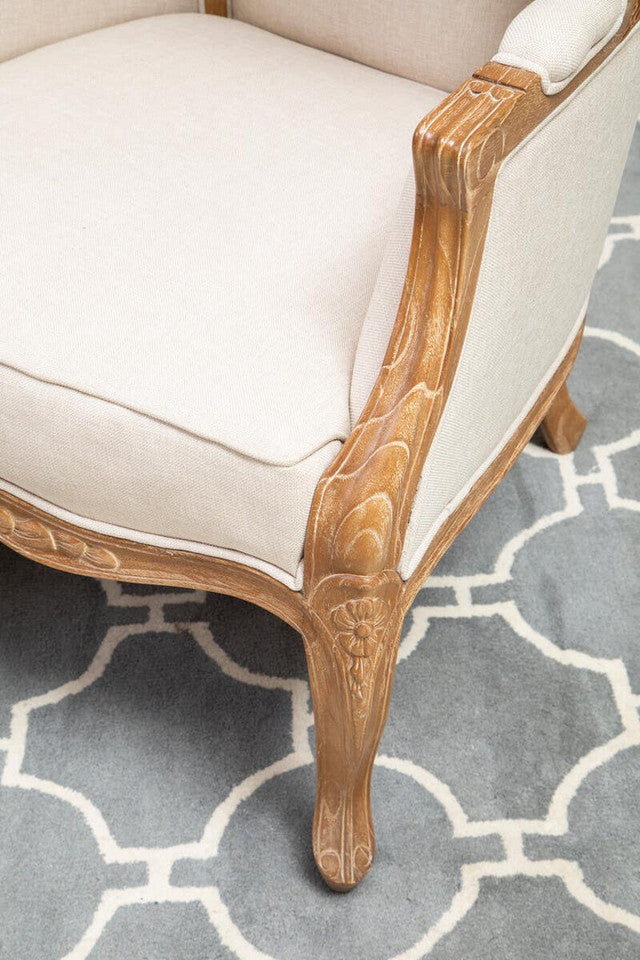 Close-up of the Colette Cream Dome Accent Chair with Canopy Back & Cabriole Legs highlighting the carved wooden arm, decorative floral carving, upholstered seat cushion and elegant French cabriole leg.