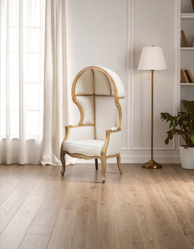 Colette Cream Dome Accent Chair with Canopy Back & Cabriole Legs styled in a bright contemporary interior, highlighting its tall canopy back, luxurious cream upholstery and statement French-inspired design.