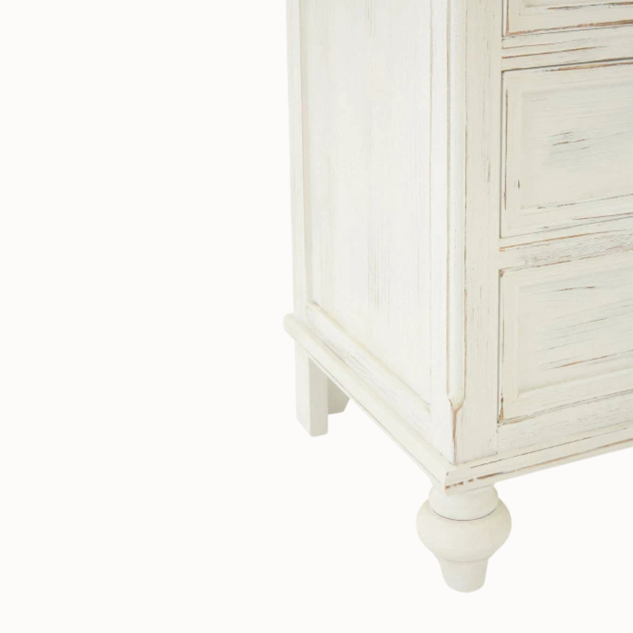 Close-up of Coralie washed ivory tallboy showing distressed wood finish, drawer front and turned foot on white background.