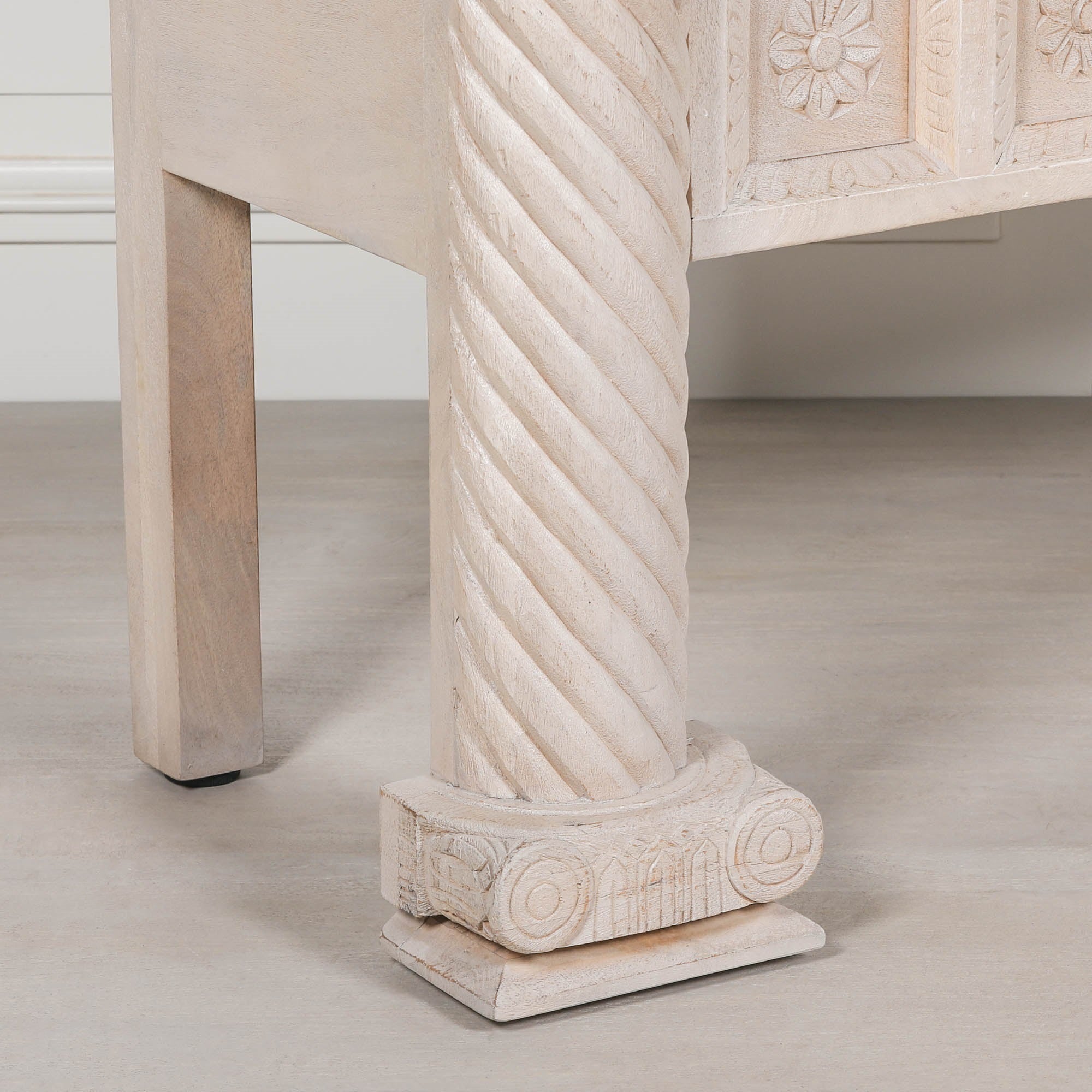 Delphine mango wood reception desk twisted carved column and decorative base against a white panelled wall