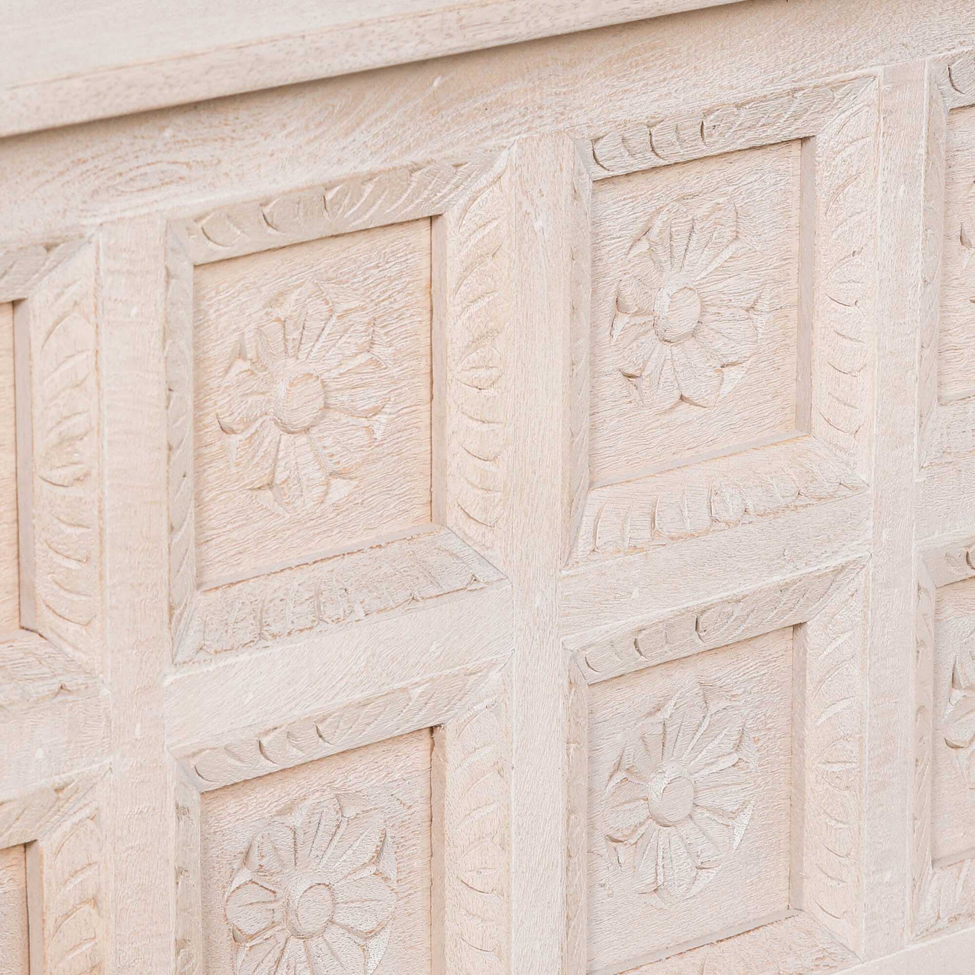 Close-up of Delphine mango wood reception desk showing detailed hand-carved floral panel design