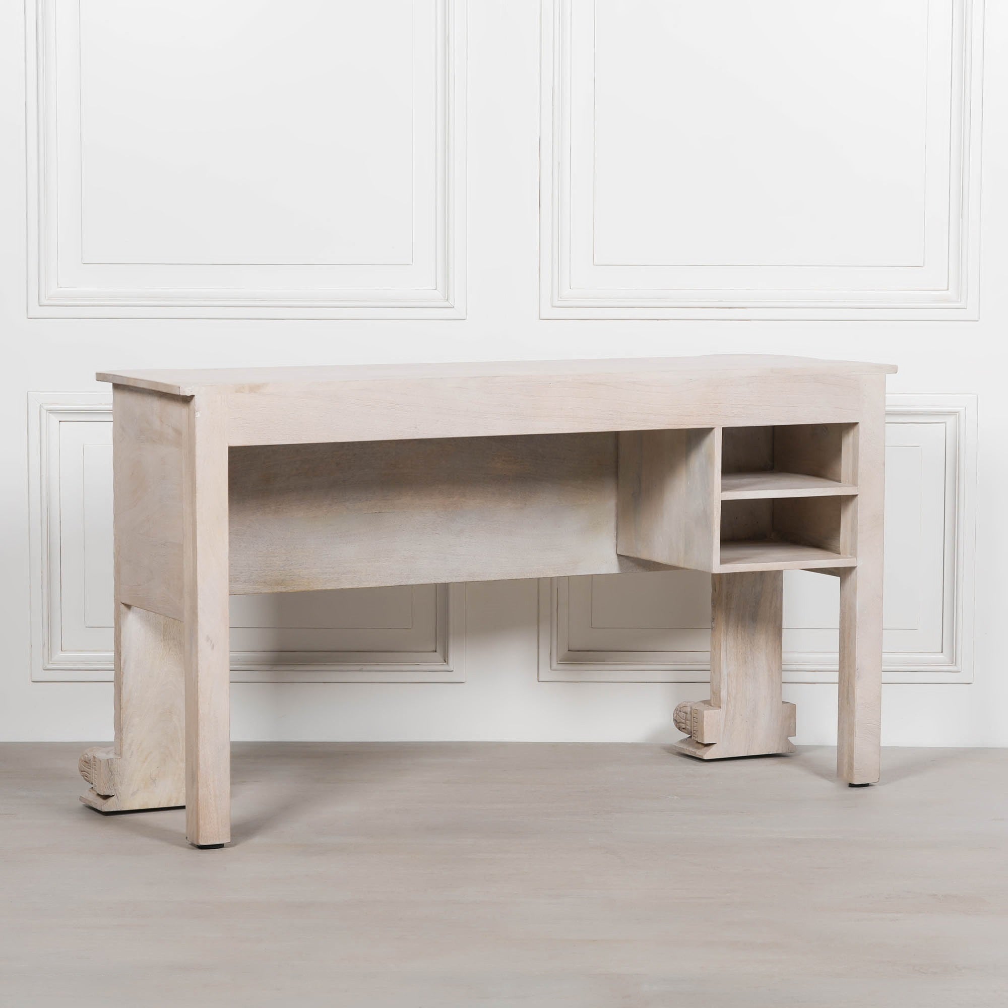 Rear view of Delphine mango wood reception desk with open storage shelves against a white panelled wall
