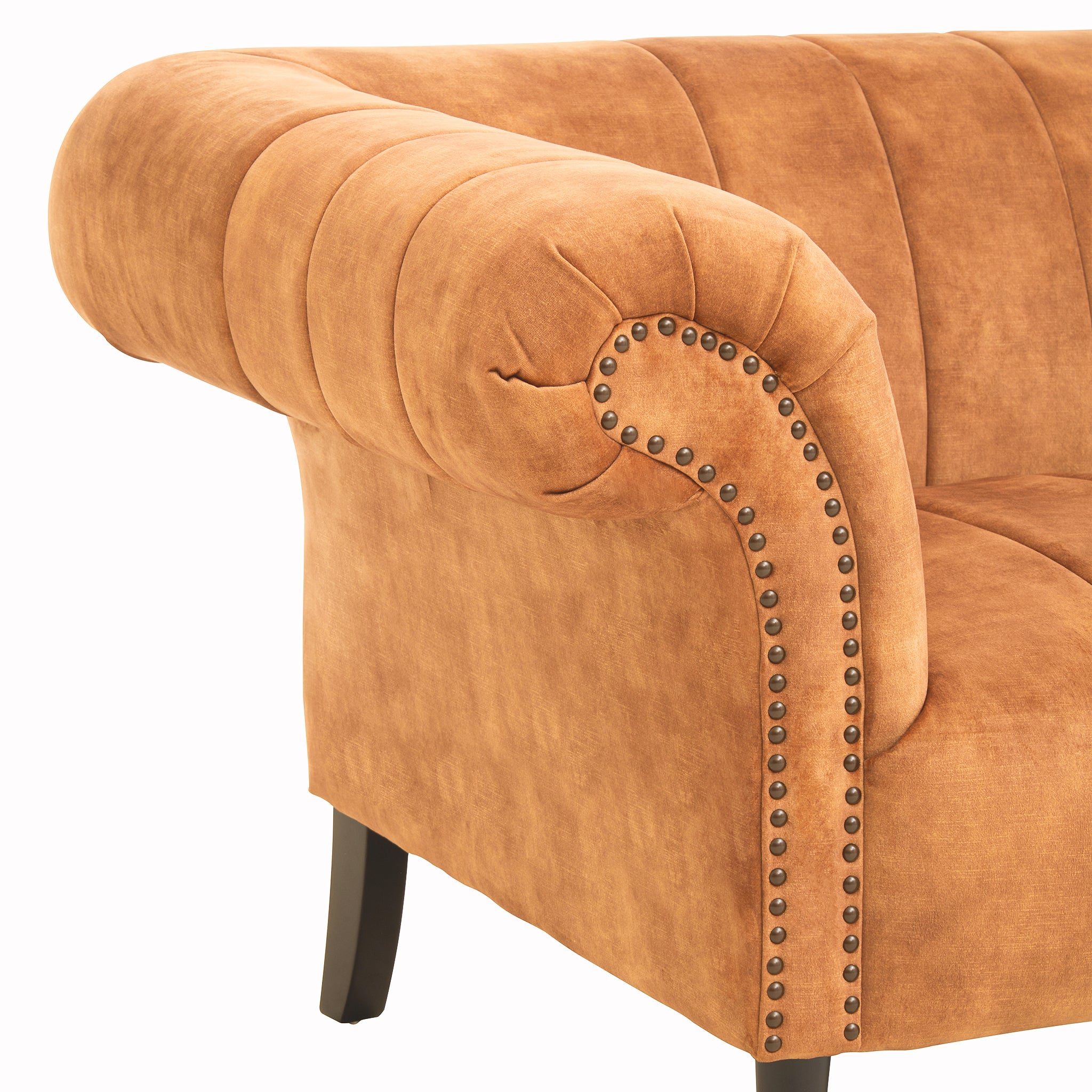 Close-up of the Elara Two Seat Sofa in Gold Velvet Upholstery highlighting the rolled scroll arm, decorative bronze nailhead trim, plush velvet fabric and vertical stitched upholstery.