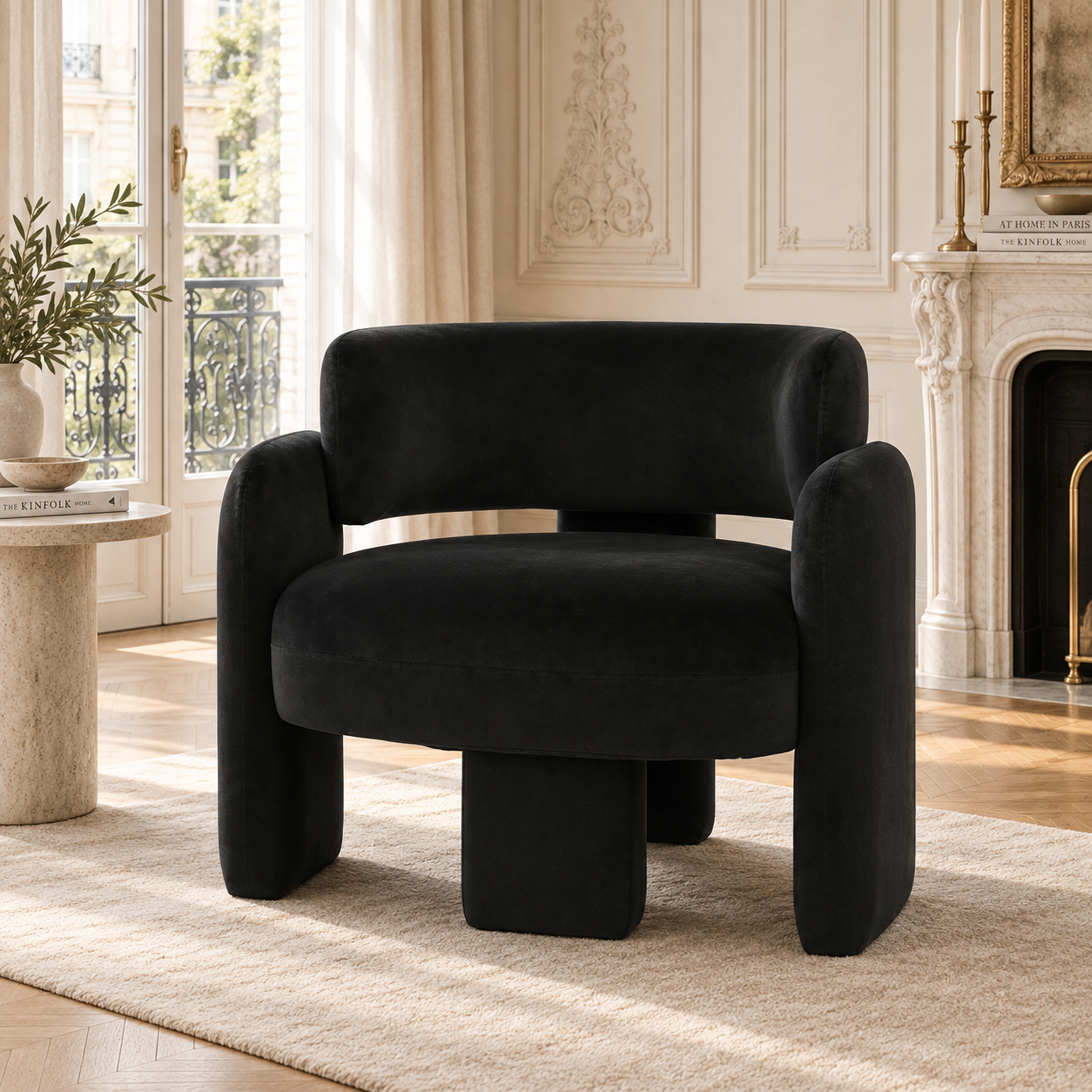 Élise black velvet curved open back accent chair in a sunlit Parisian living room with marble fireplace.