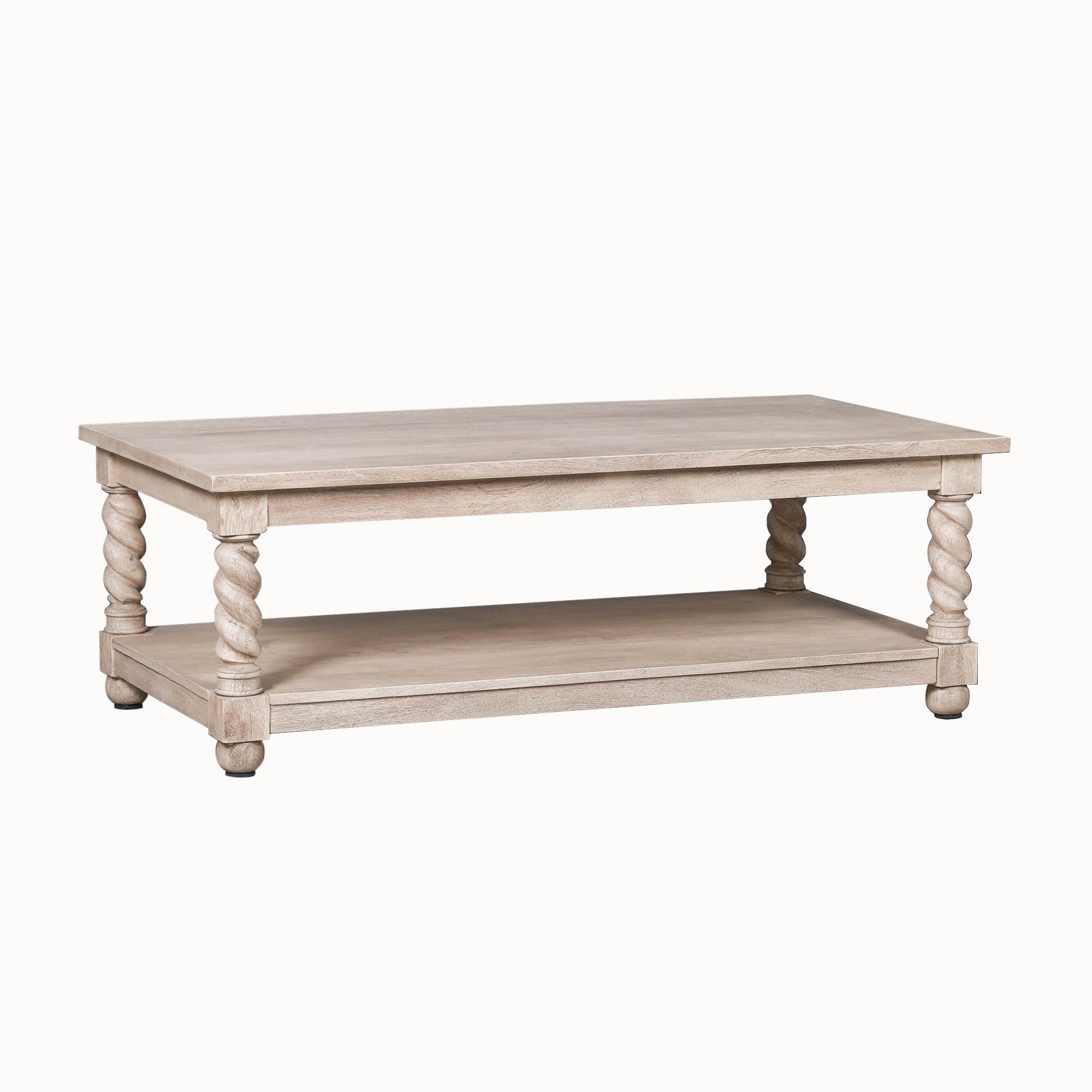 Éloi rectangular acacia wood coffee table shown on a white background, with four hand-carved twisted twirl legs, substantial wooden top and full-width lower storage shelf.
