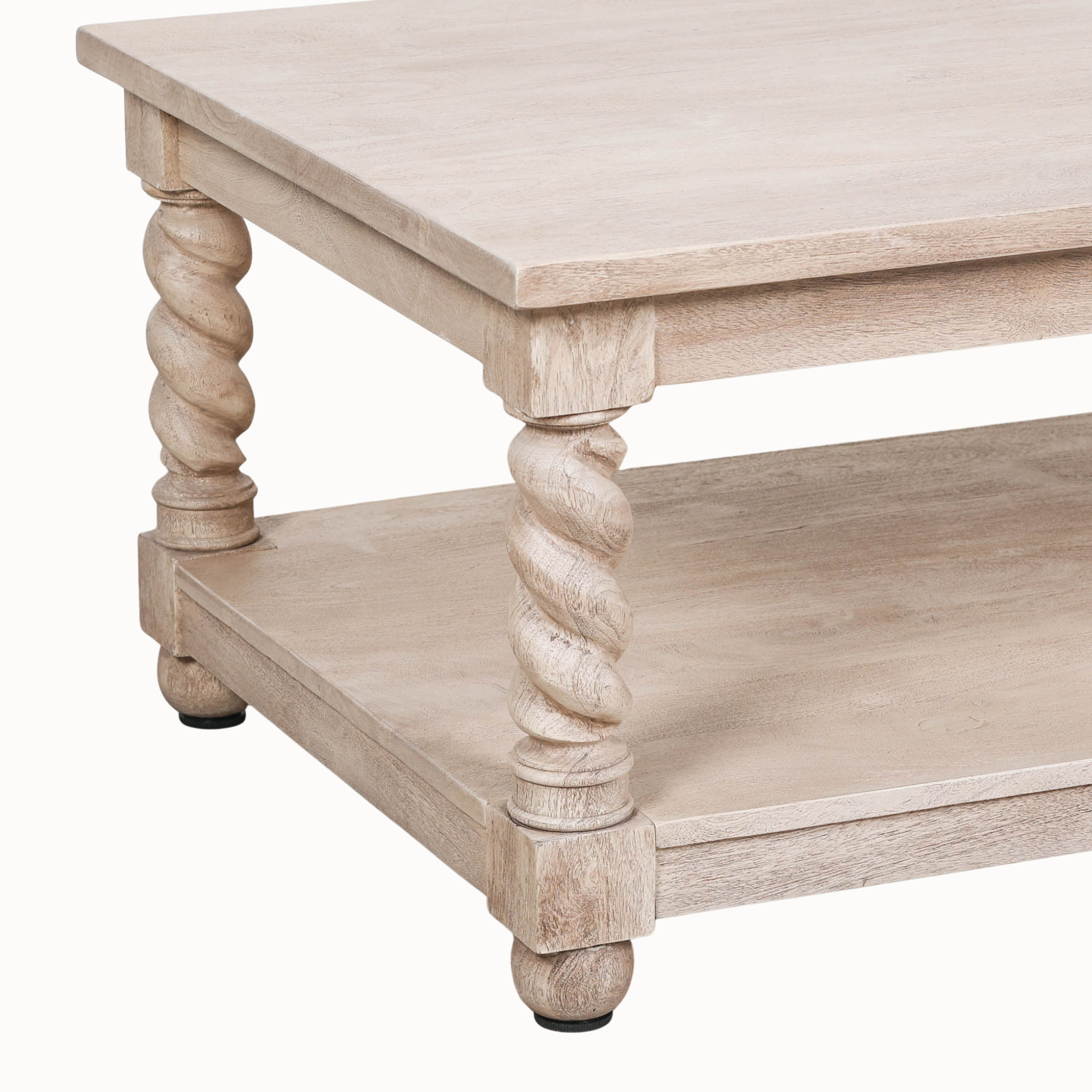 Close-up of Éloi acacia wood coffee table showing lower shelf and hand-carved twirl legs against a white background.