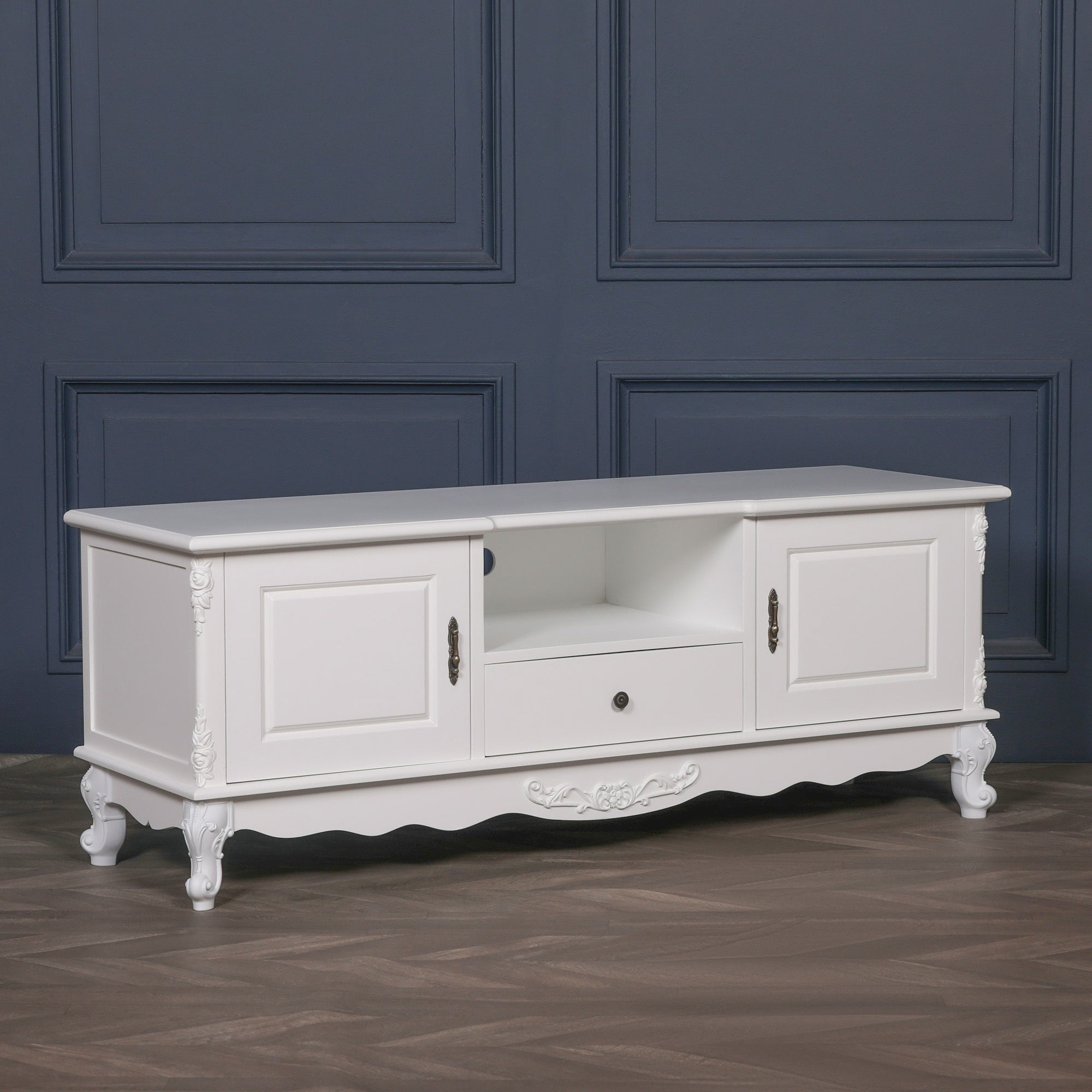 Angled view of the Éloise Large French White TV Cabinet featuring carved cabriole legs, spacious entertainment storage, white painted finish and classic French country design.