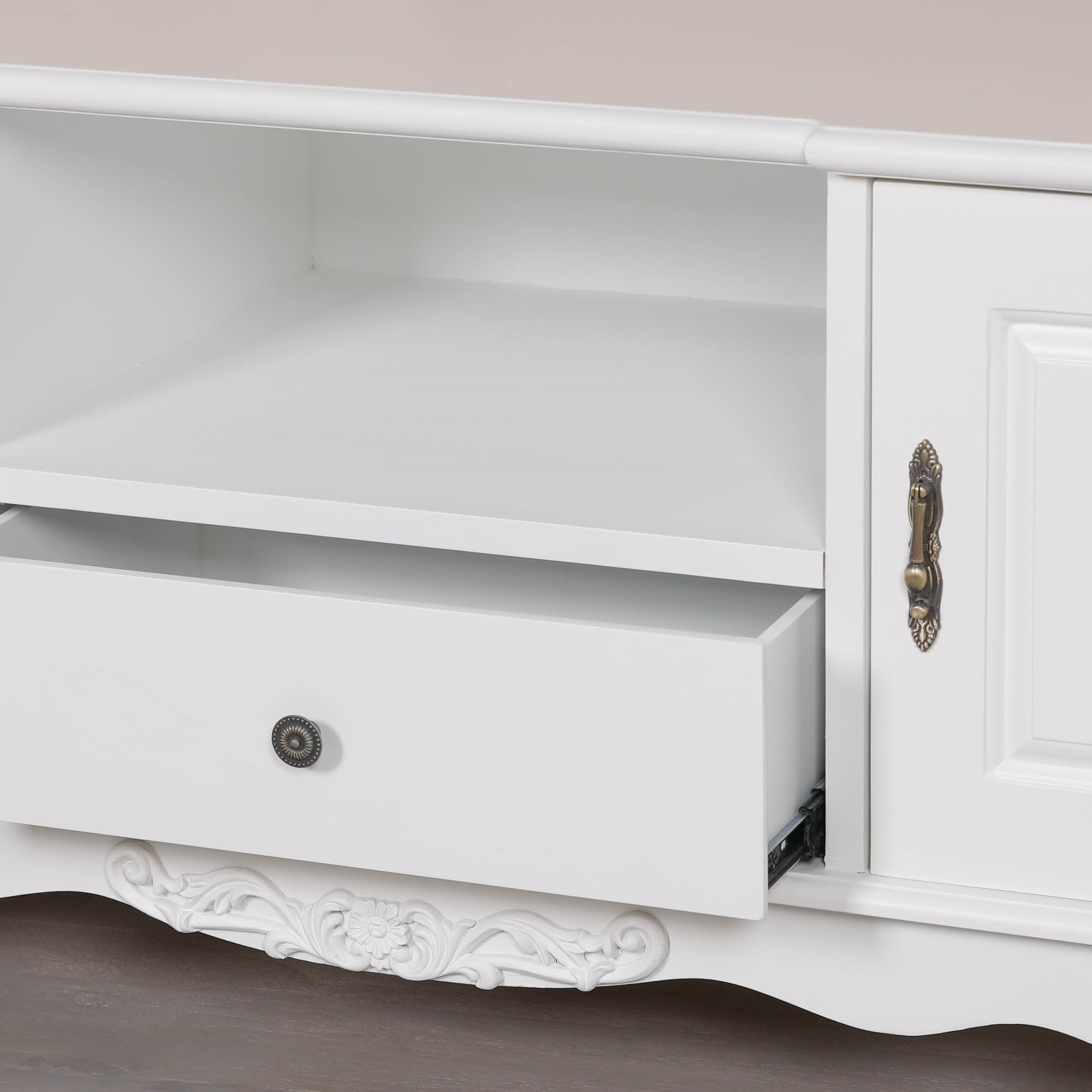 Detailed view of the Éloise Large French White TV Cabinet with partially open drawer, internal storage shelf, decorative brass hardware and handcrafted French country furniture detailing.