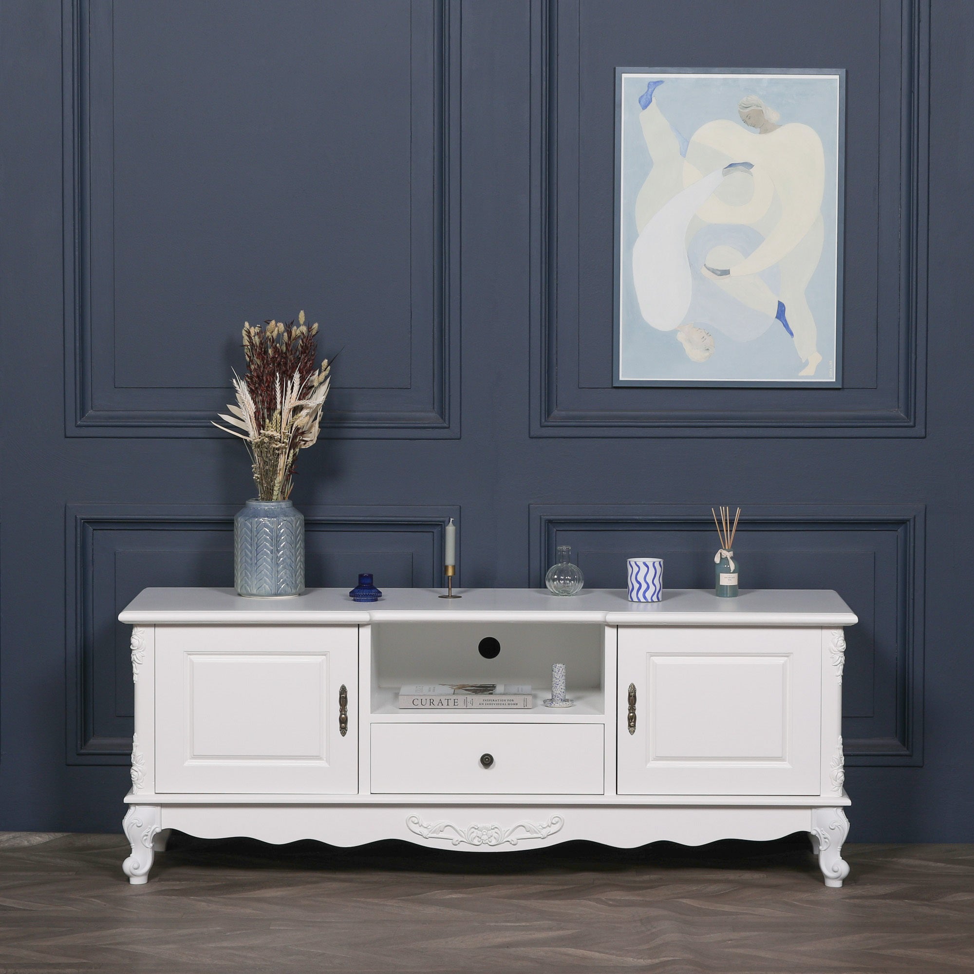 Éloise Large French White TV Cabinet styled with decorative accessories, featuring hand-carved detailing, elegant white finish, media storage and luxury French country living room design.