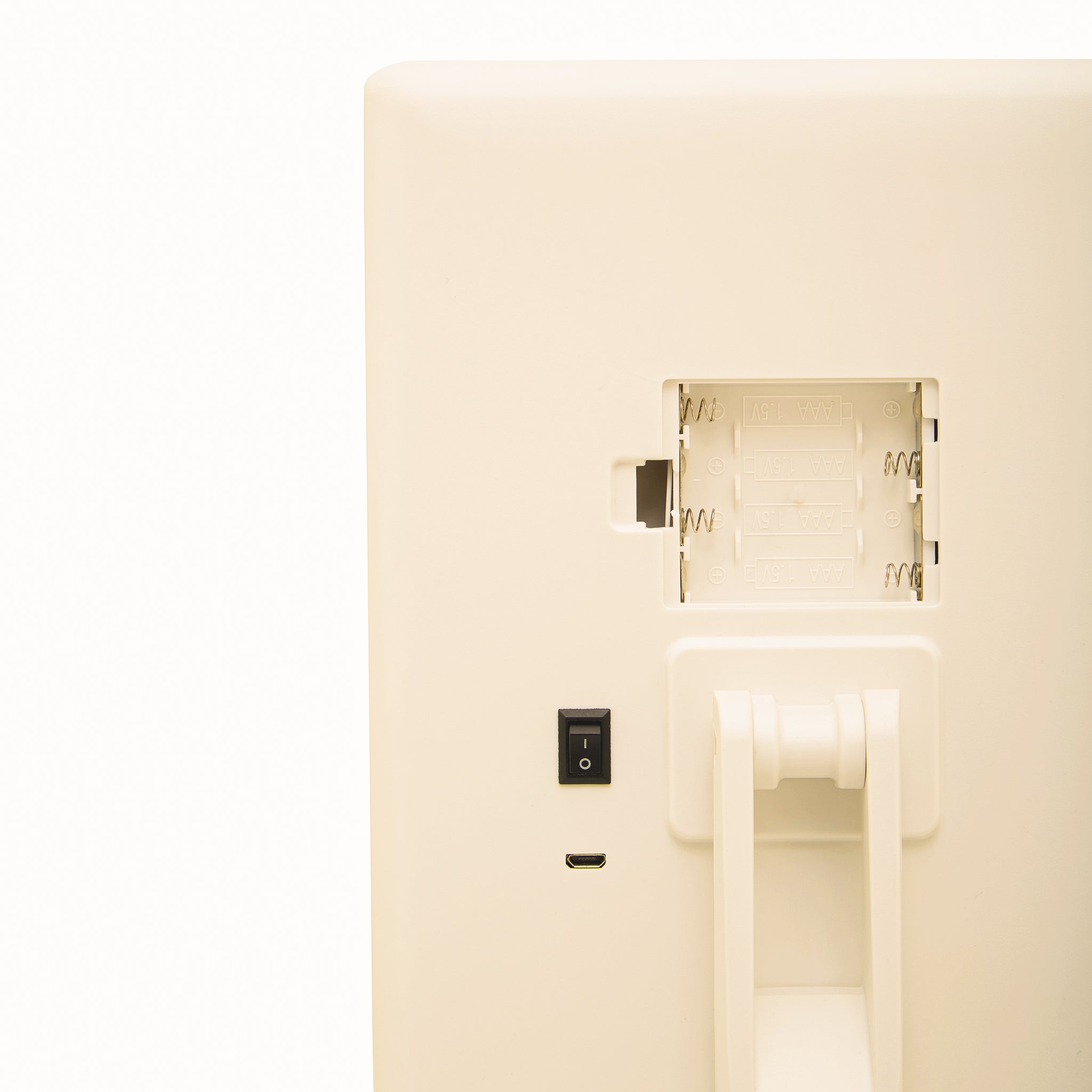 Close-up rear view of the Émile White LED Tri-Fold Vanity Mirror showing the open battery compartment, power switch, charging port and adjustable tabletop stand.